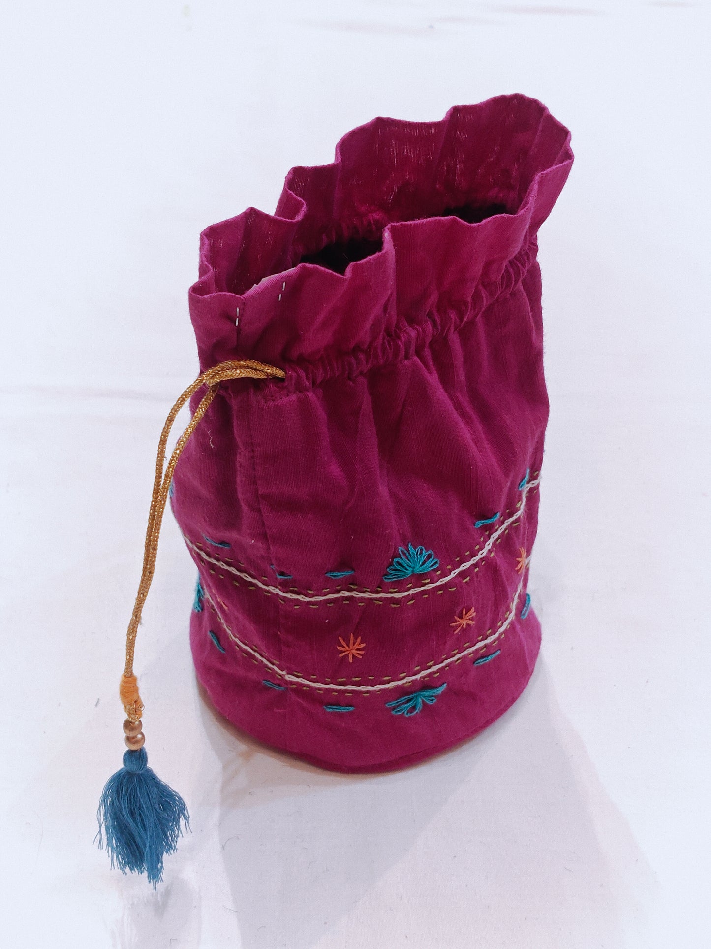 Pink hand embroidered cotton potli with base