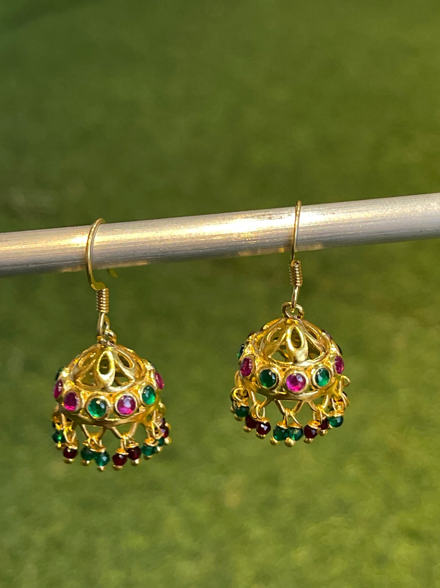 Gold polish jhumkis with pink and green stones in 92.5 sterling silver hooks earrings