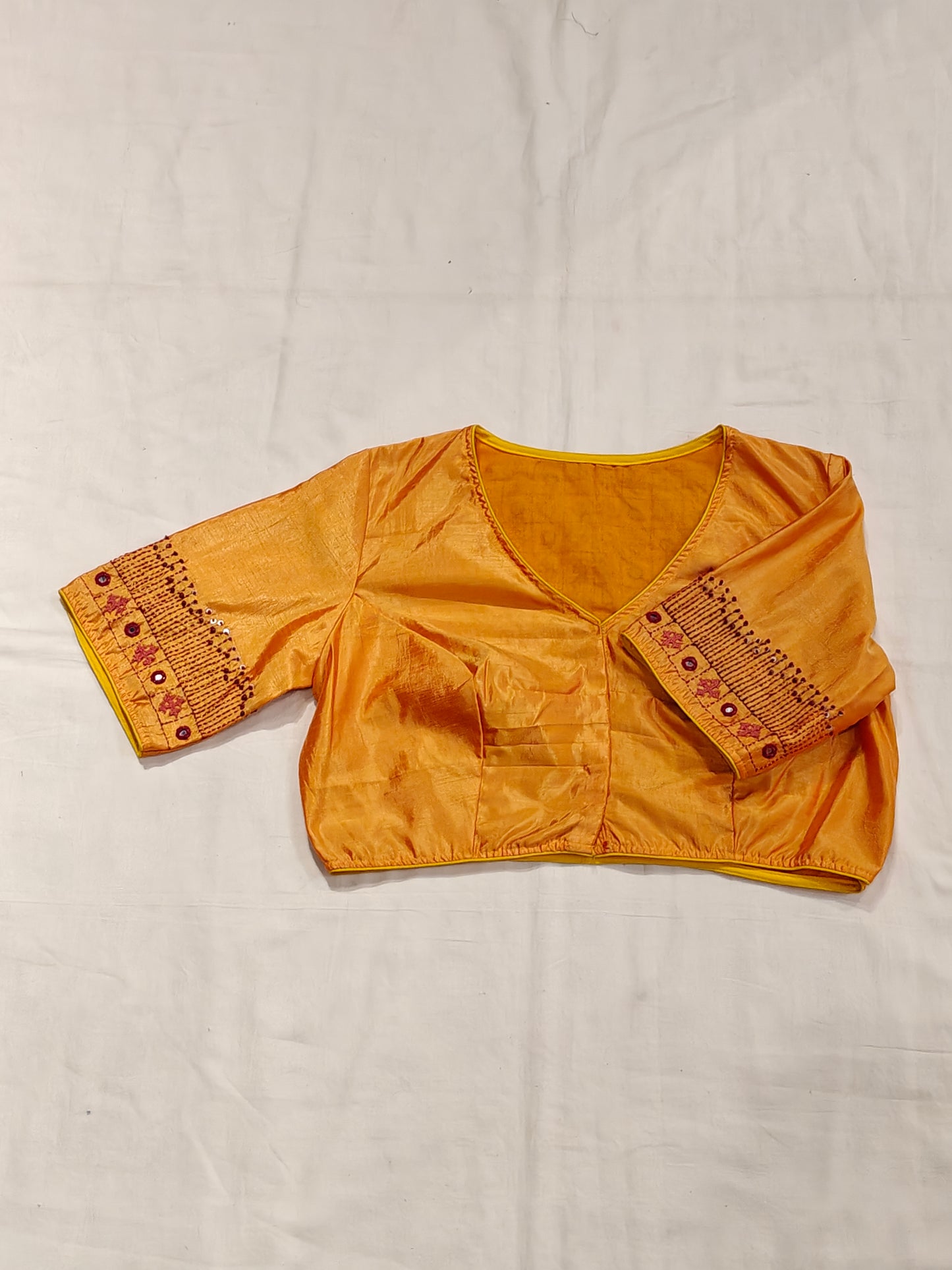 Orangeish yellow silk blouse with Kutchi hand mirror embroidery for back and sleeves