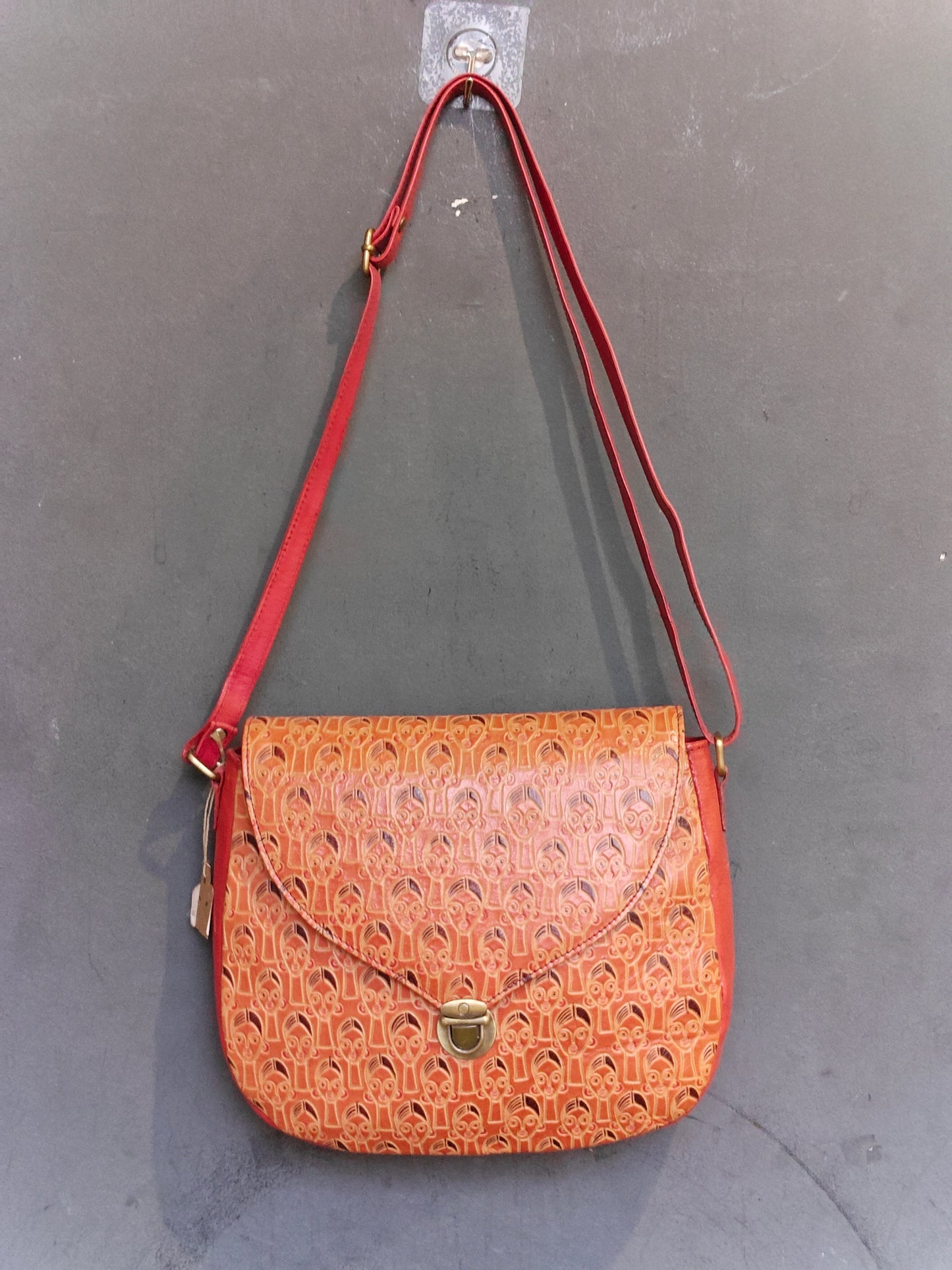Leather hand crafted, hand painted adjustable length sling bag with metal clasp