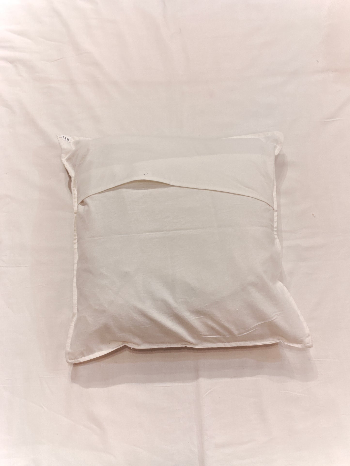 White cushion cover featuring horizontal and vertical stripes