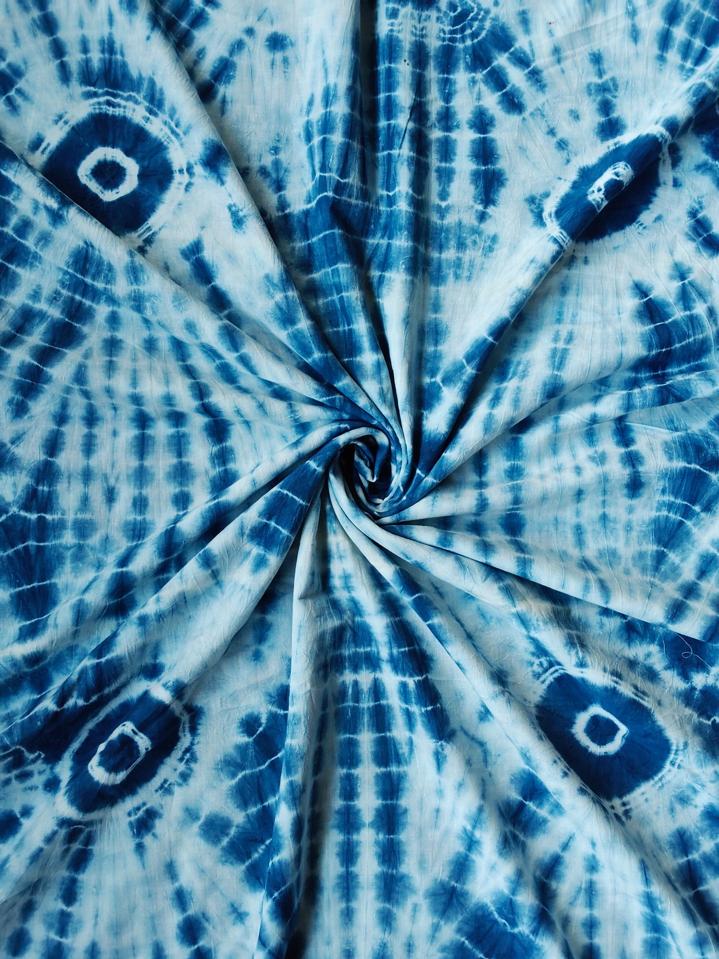 Blue and white tie and dye sun burst pattern fabric