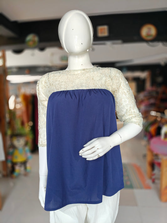 Navy blue top featuring cream lace sleeves and yoke