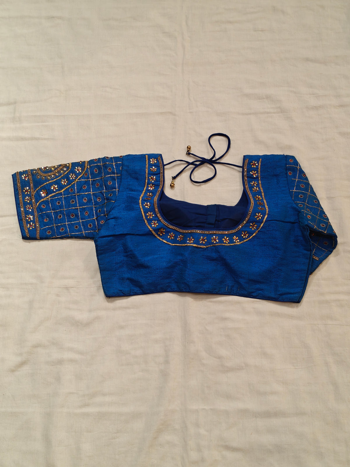 Blue blouse with golden embroidery and stonework on sleeves and half neck - elbow sleeved, front open