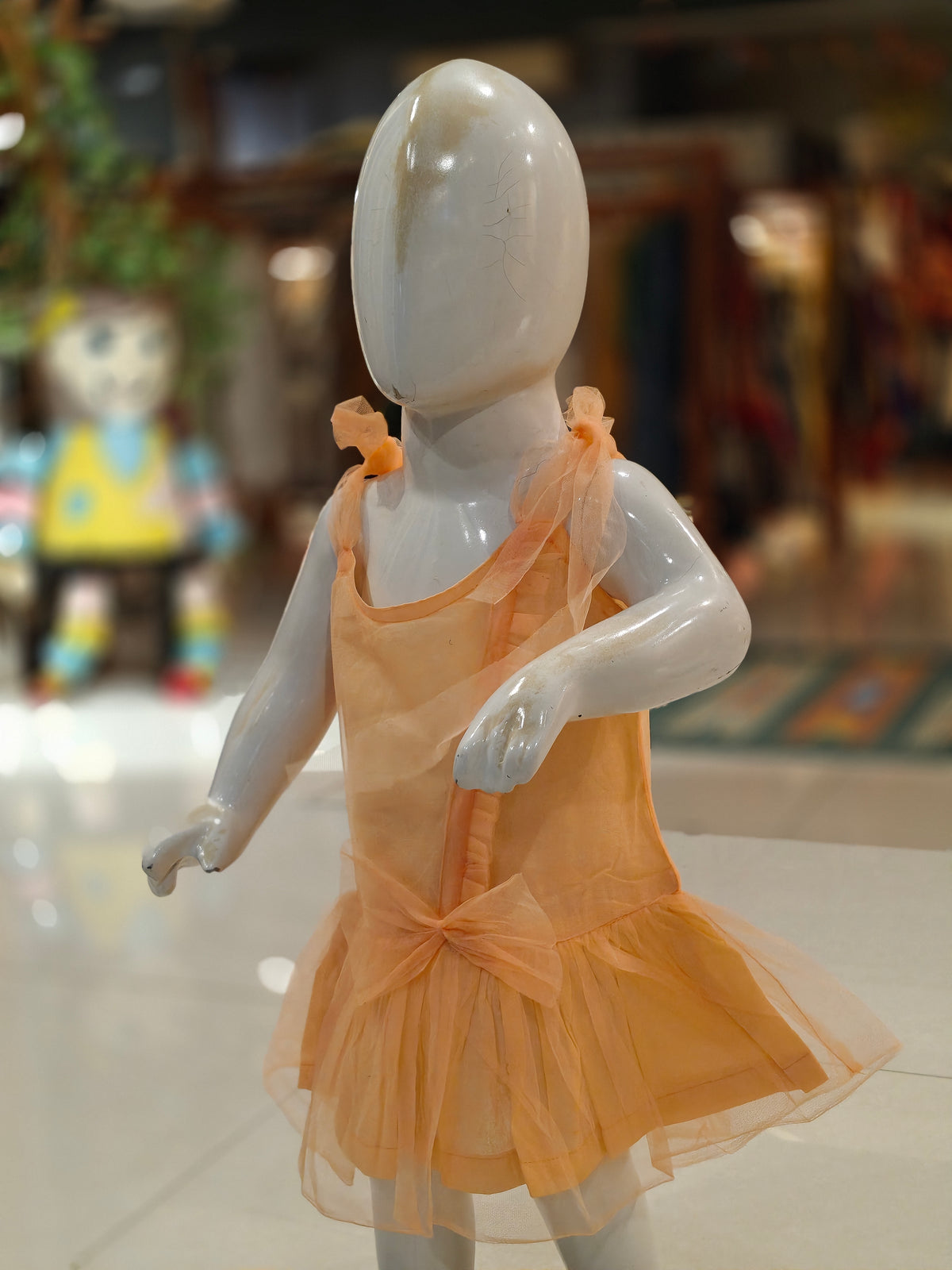 Peach sleeveless net frock for girls with shoulder ties and lining
