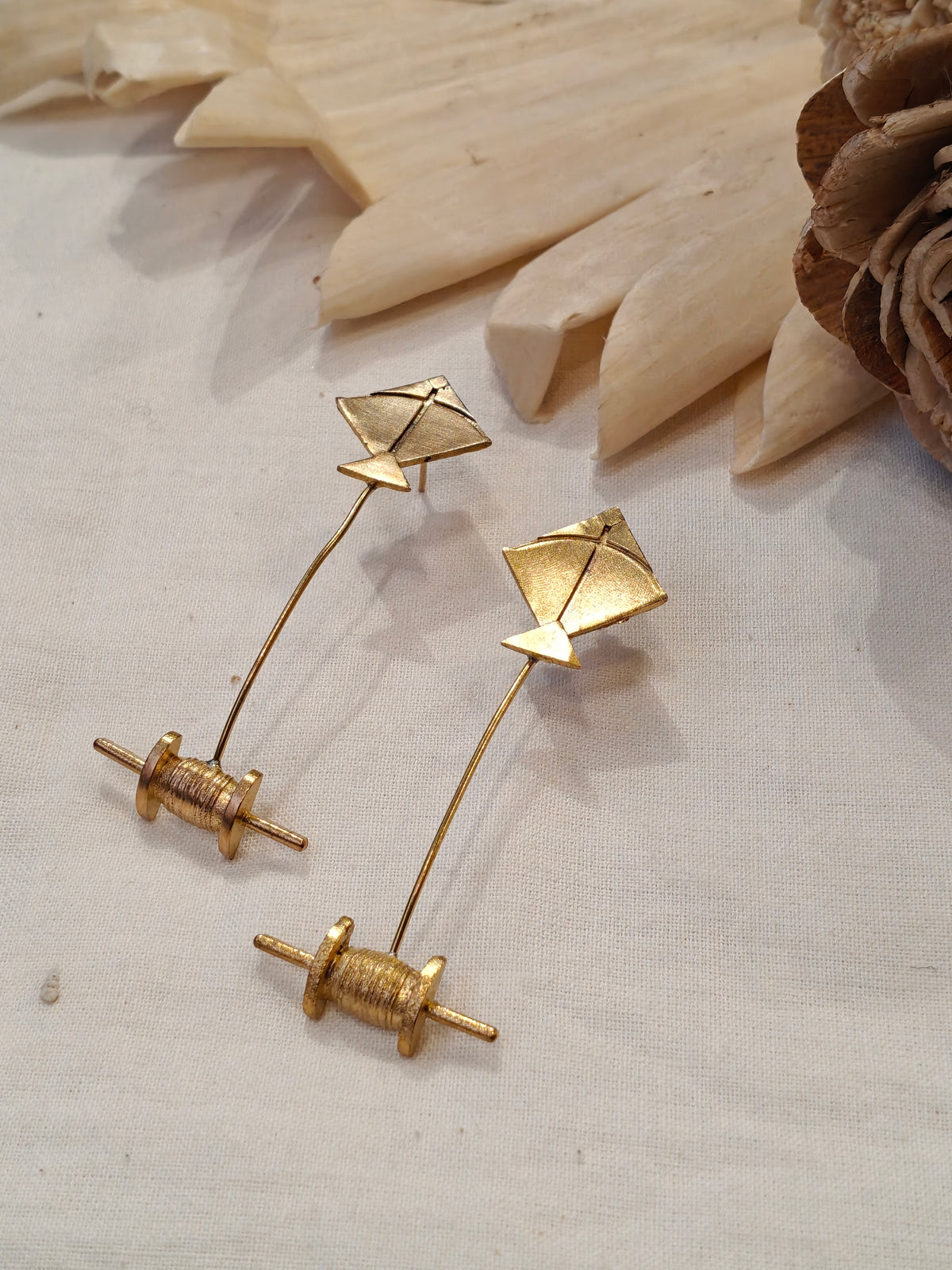 Kite and spool shaped brass earrings
