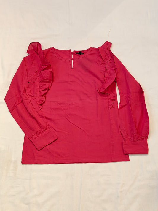 Pink cotton top with ruffled detailing along shoulders