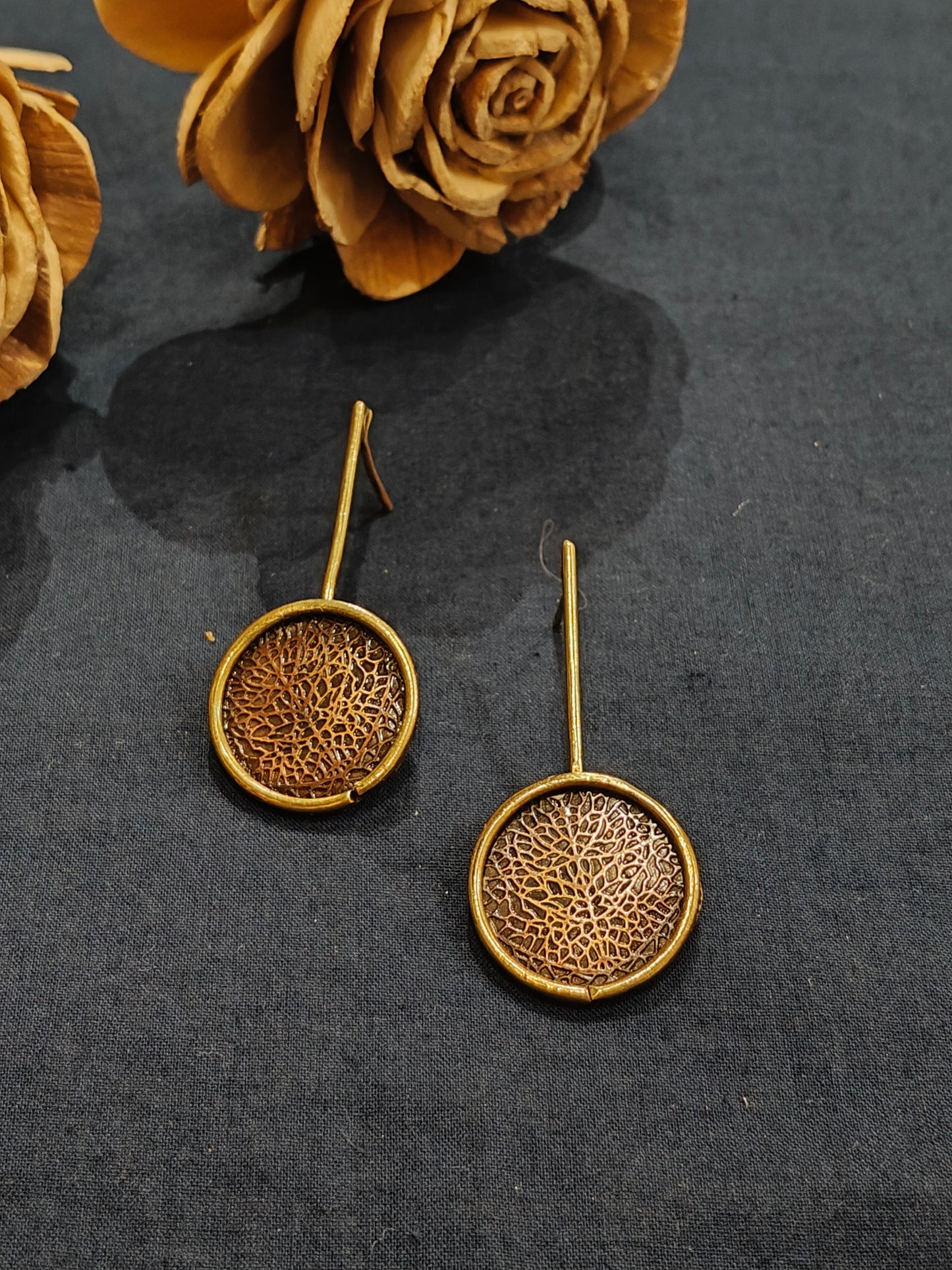 Circular handcrafted stud earrings in copper and brass