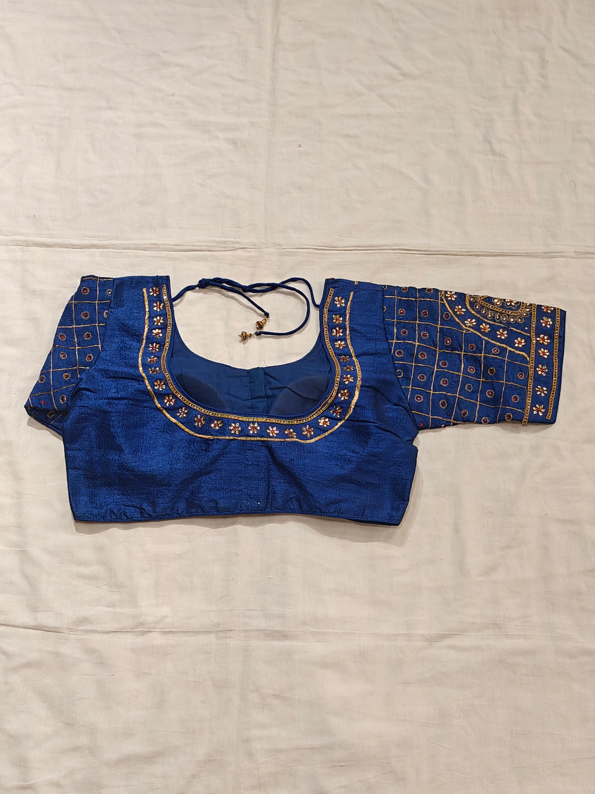 Blouse with golden embroidery and stonework on sleeves and half neck