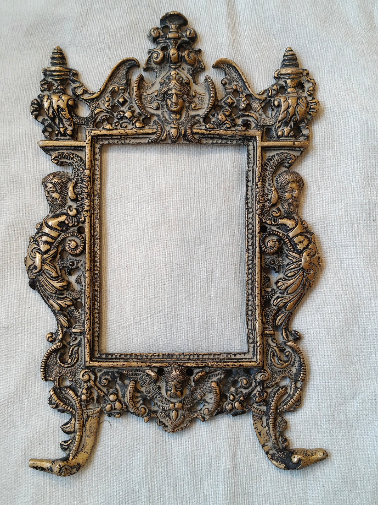 Vintage brass handcrafted wall frame with mythological carvings