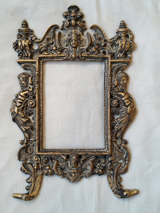 Vintage brass handcrafted wall frame with mythological carvings