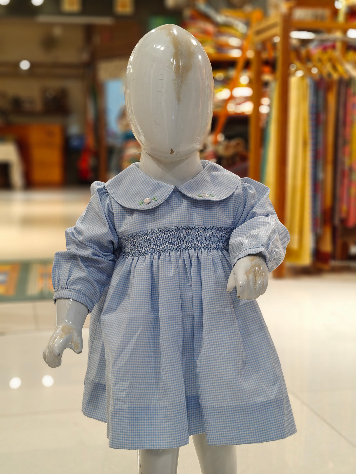 Checks smocking cotton frock for girls with embroidered Peter Pan collar and long sleeves