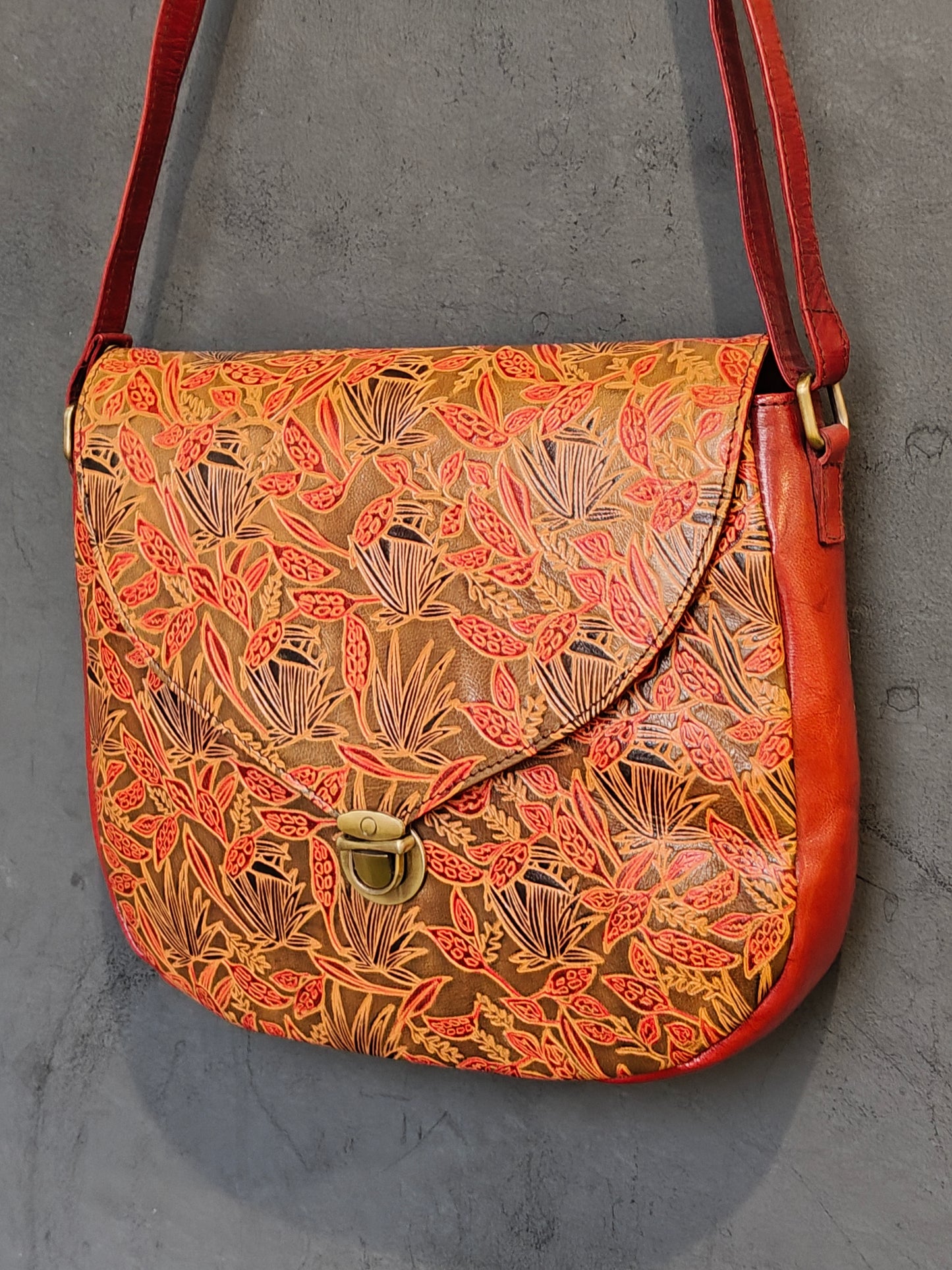 Leather hand crafted, hand painted adjustable length sling bag with metal clasp