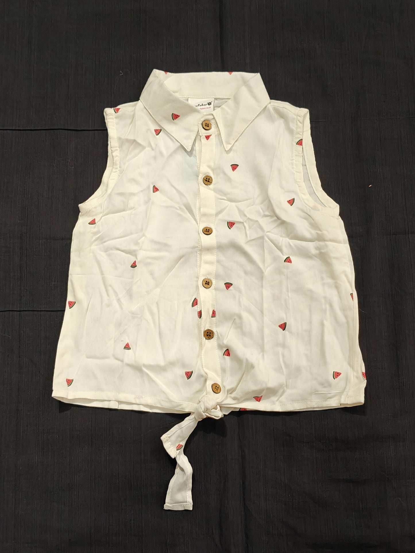 White sleeveless top with watermelon prints and button down tie up hem