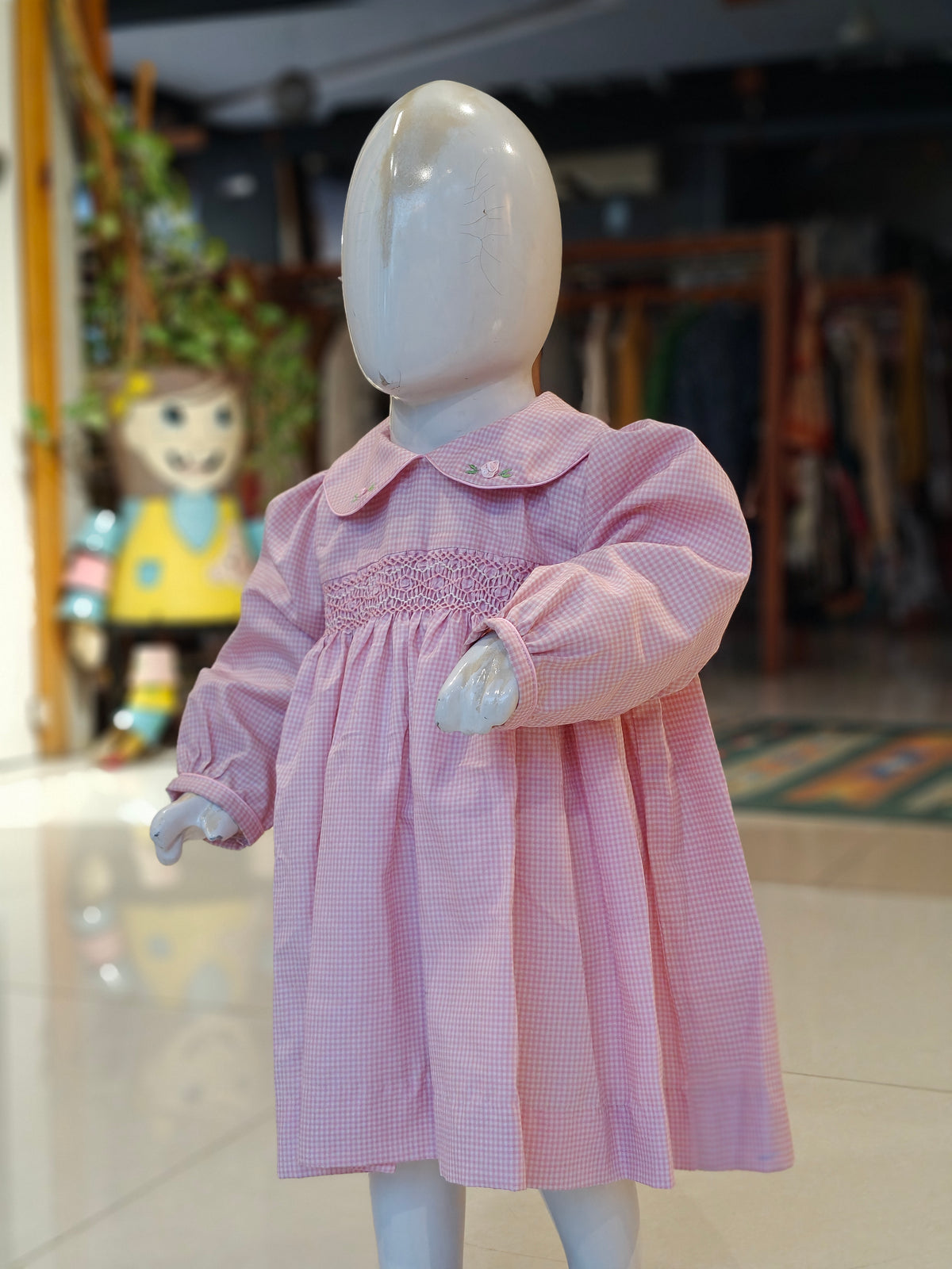 Checks smocking cotton frock for girls with embroidered Peter Pan collar and long sleeves