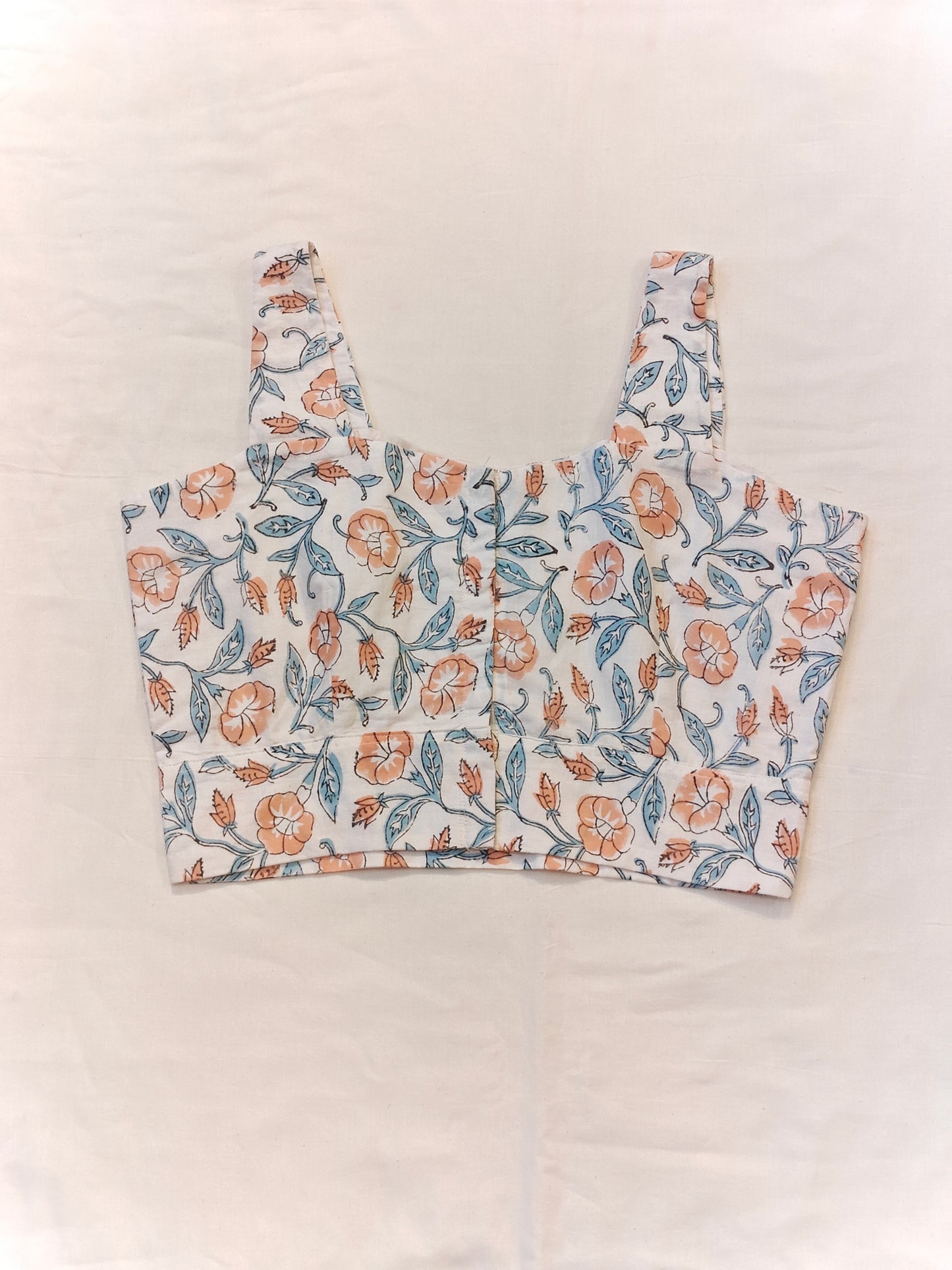 Orange floral prints on white base sleeveless blouse / crop top