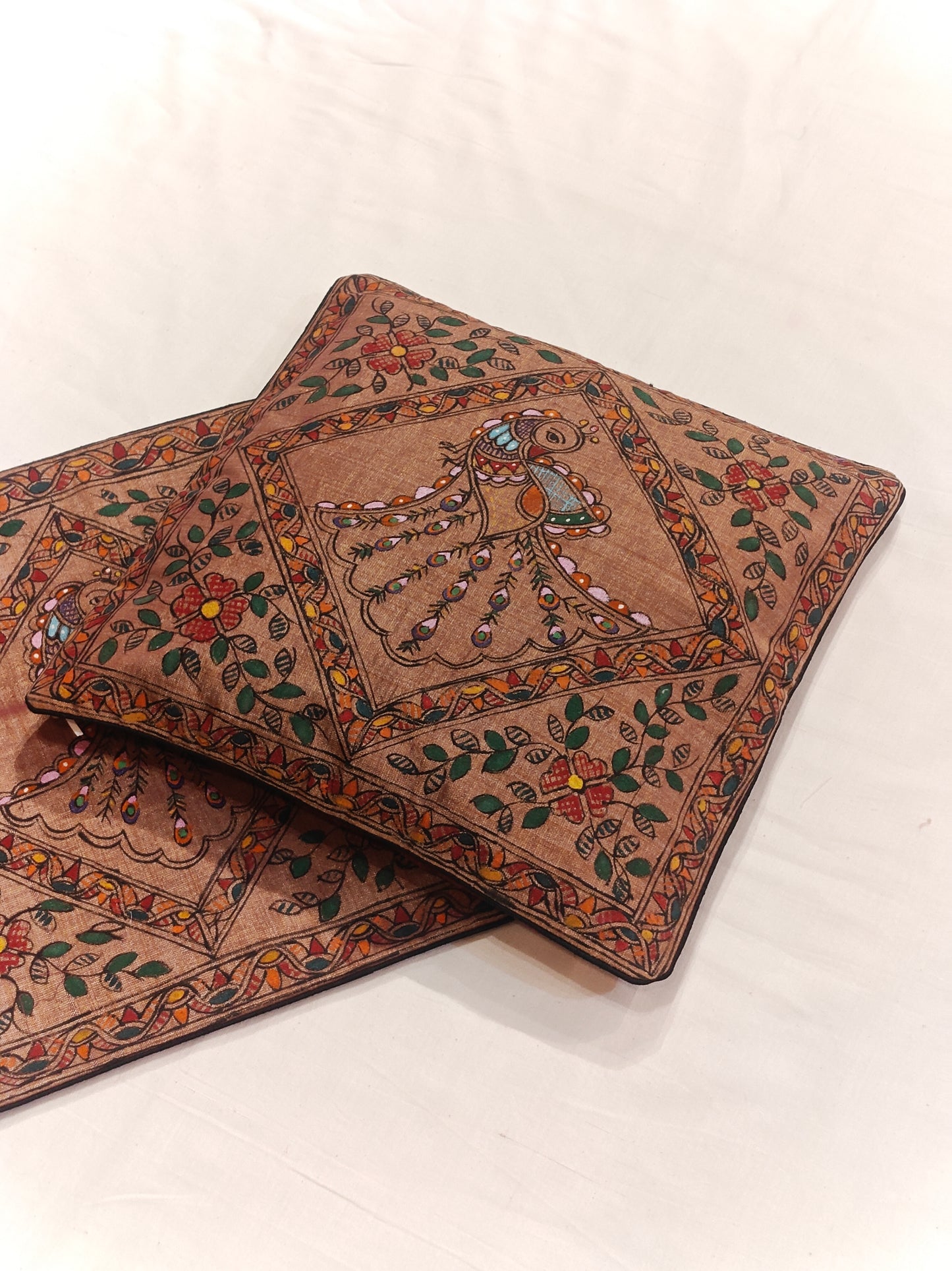 Brown cushion cover with Madhubani peacock hand painted designs