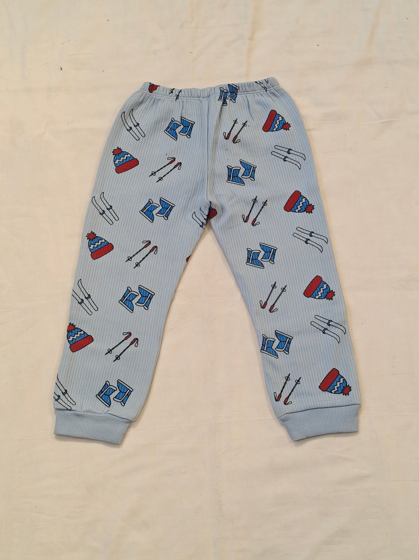 Blue thermal pants for kids with skiing tools prints