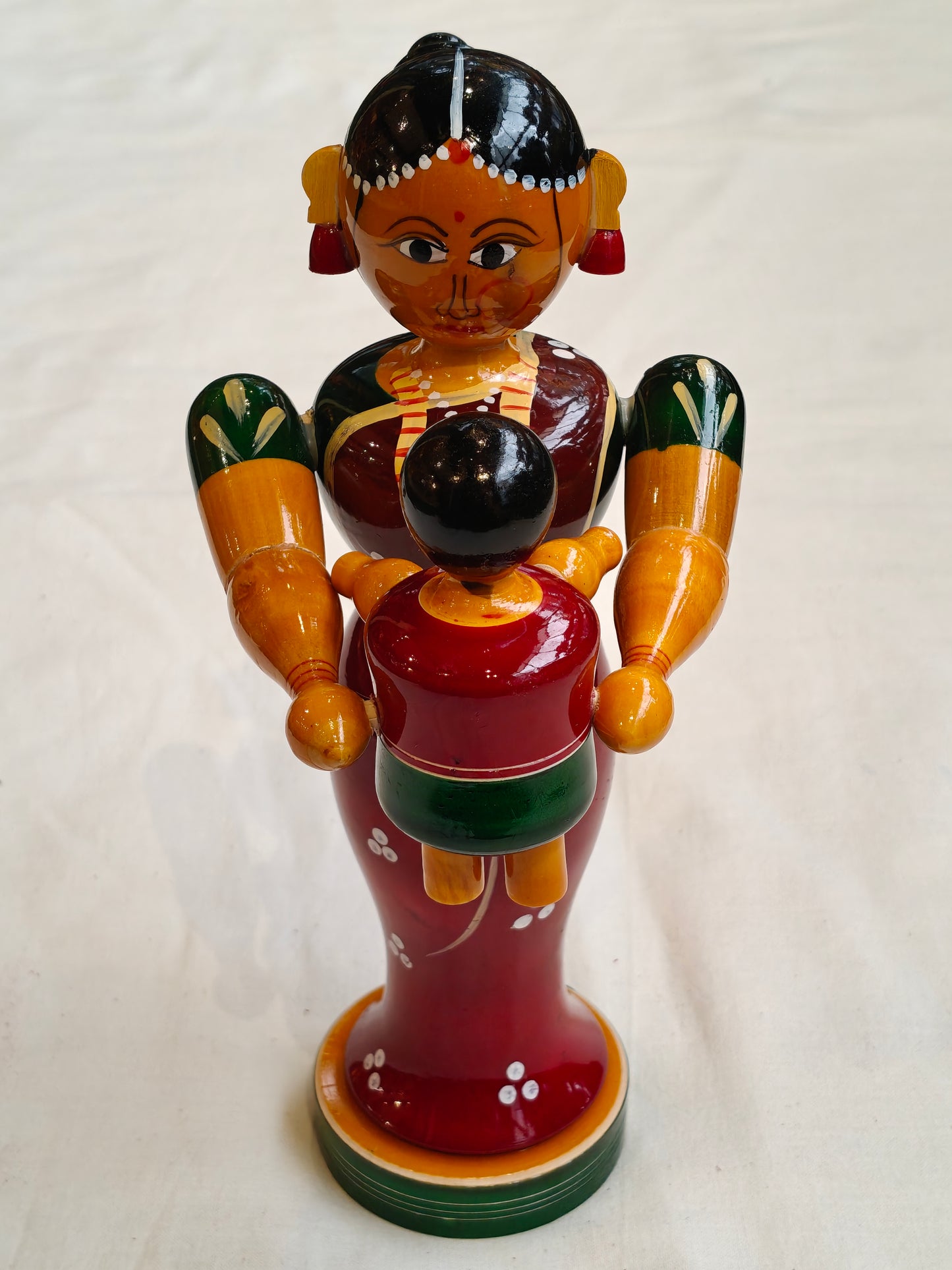 Mother tossing baby - handcrafted wooden decor