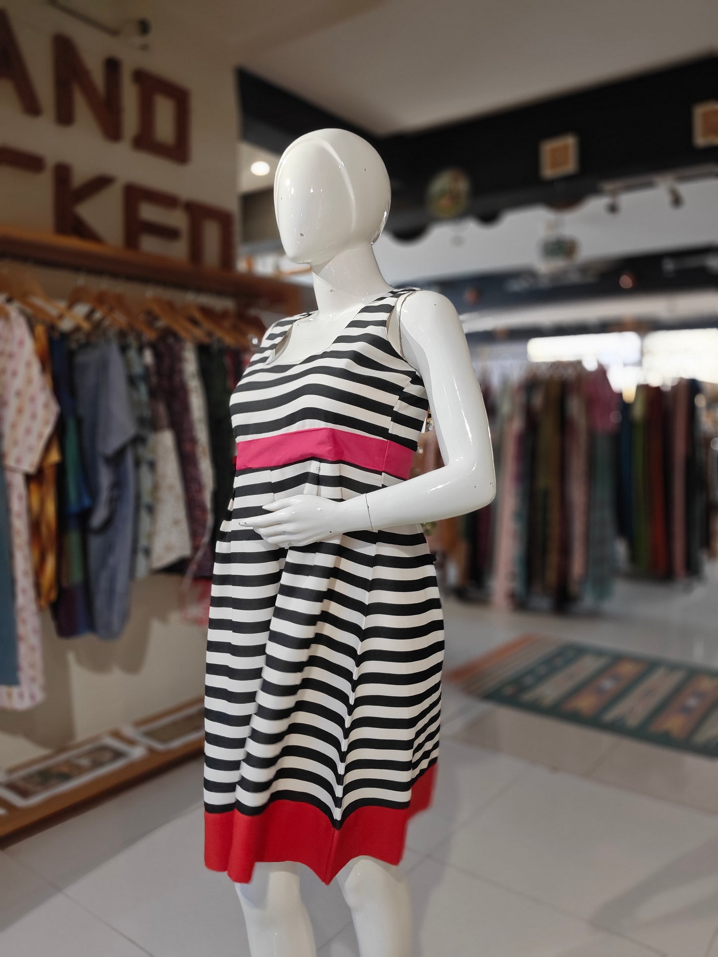 White and black striped skater dress with pink waist line and red hem