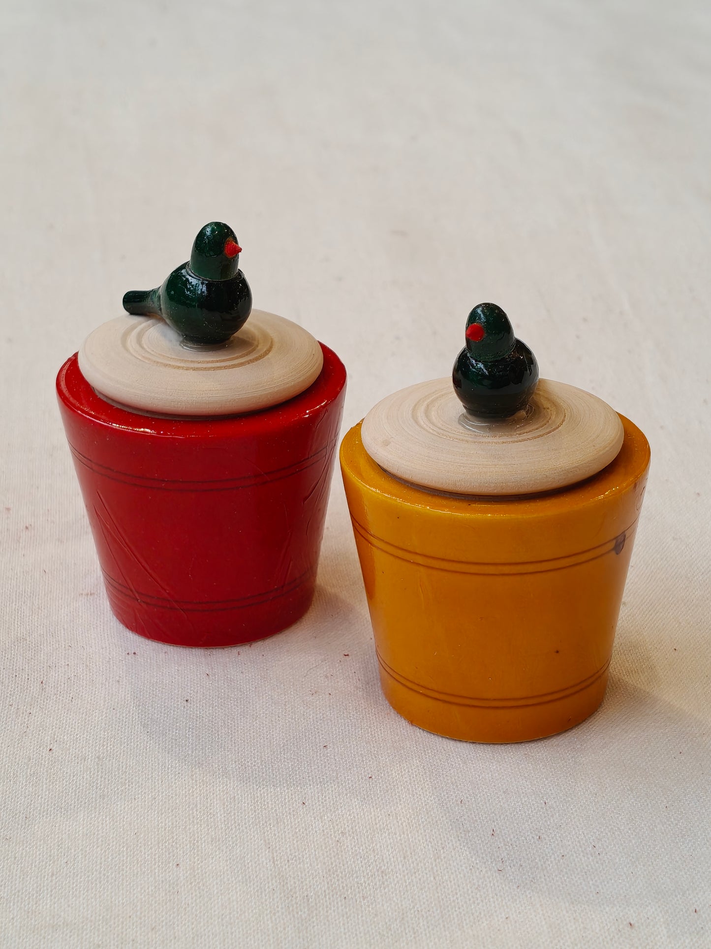 Wooden handcrafted haldi kumkum containers with a parrot on lid