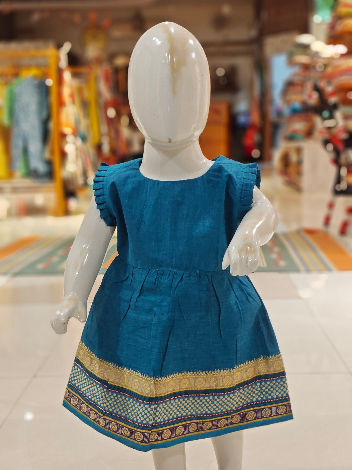 Blue ethnic cotton frock for girls with colorful border at hem