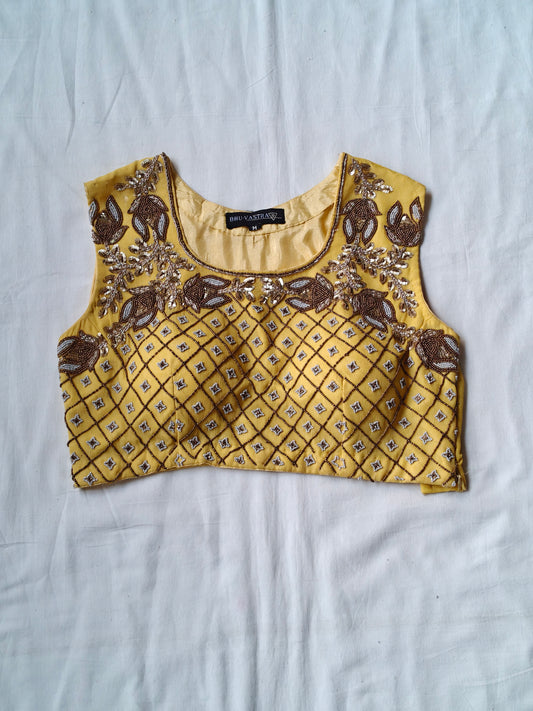 Yellow sleeveless blouse with beaded hand embroidery in diamond pattern with floral motifs