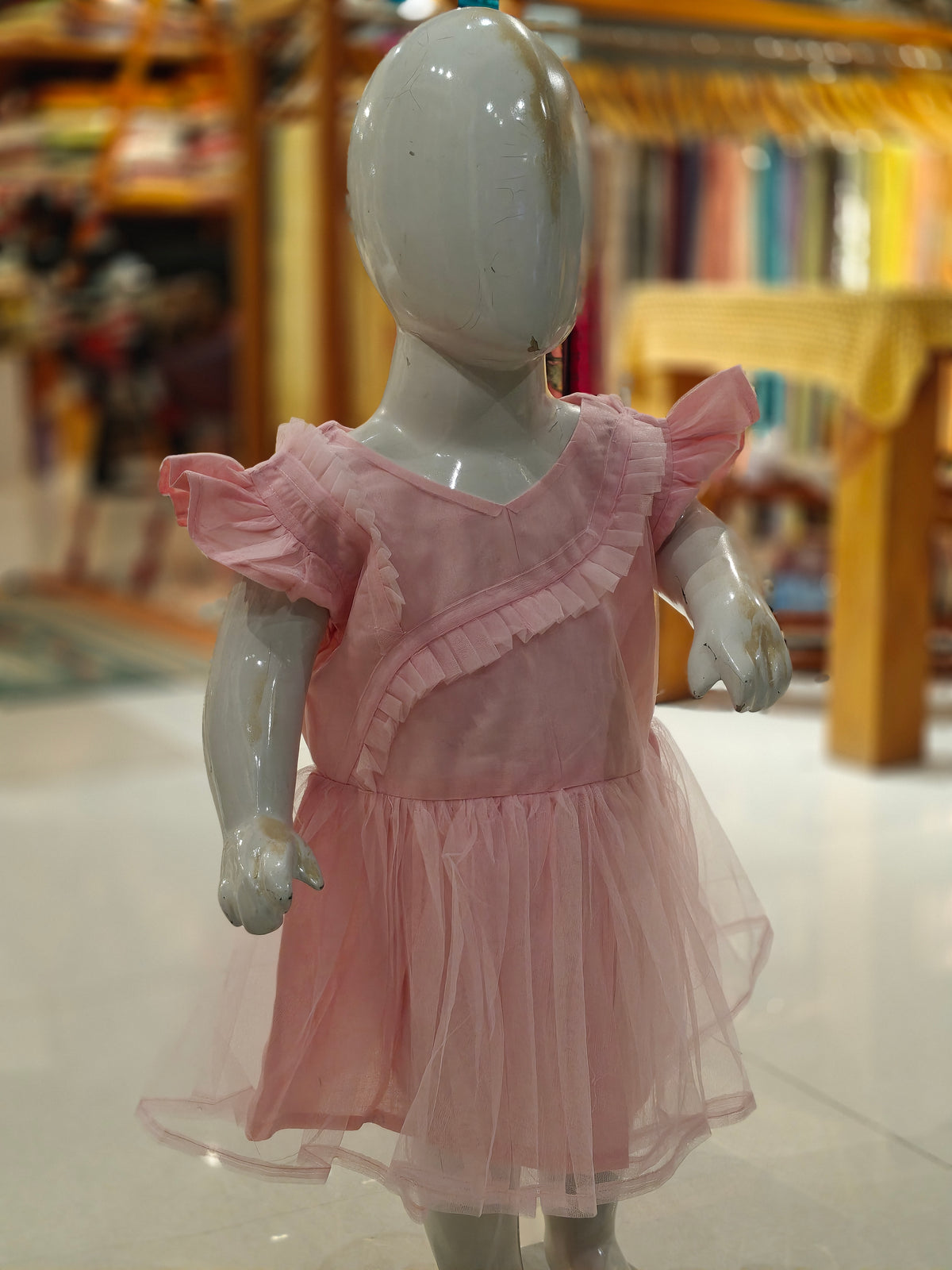 Pink net frock for girls with frilly sleeves and cotton lining