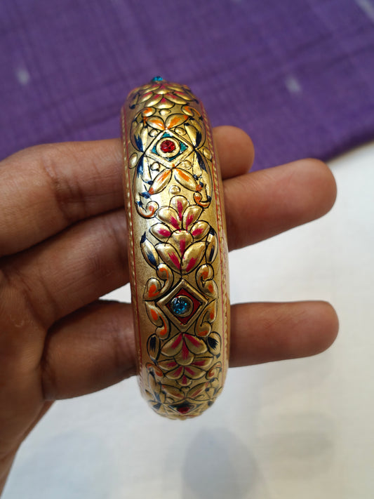 Single gold embossed wide bangle with blue and red stones