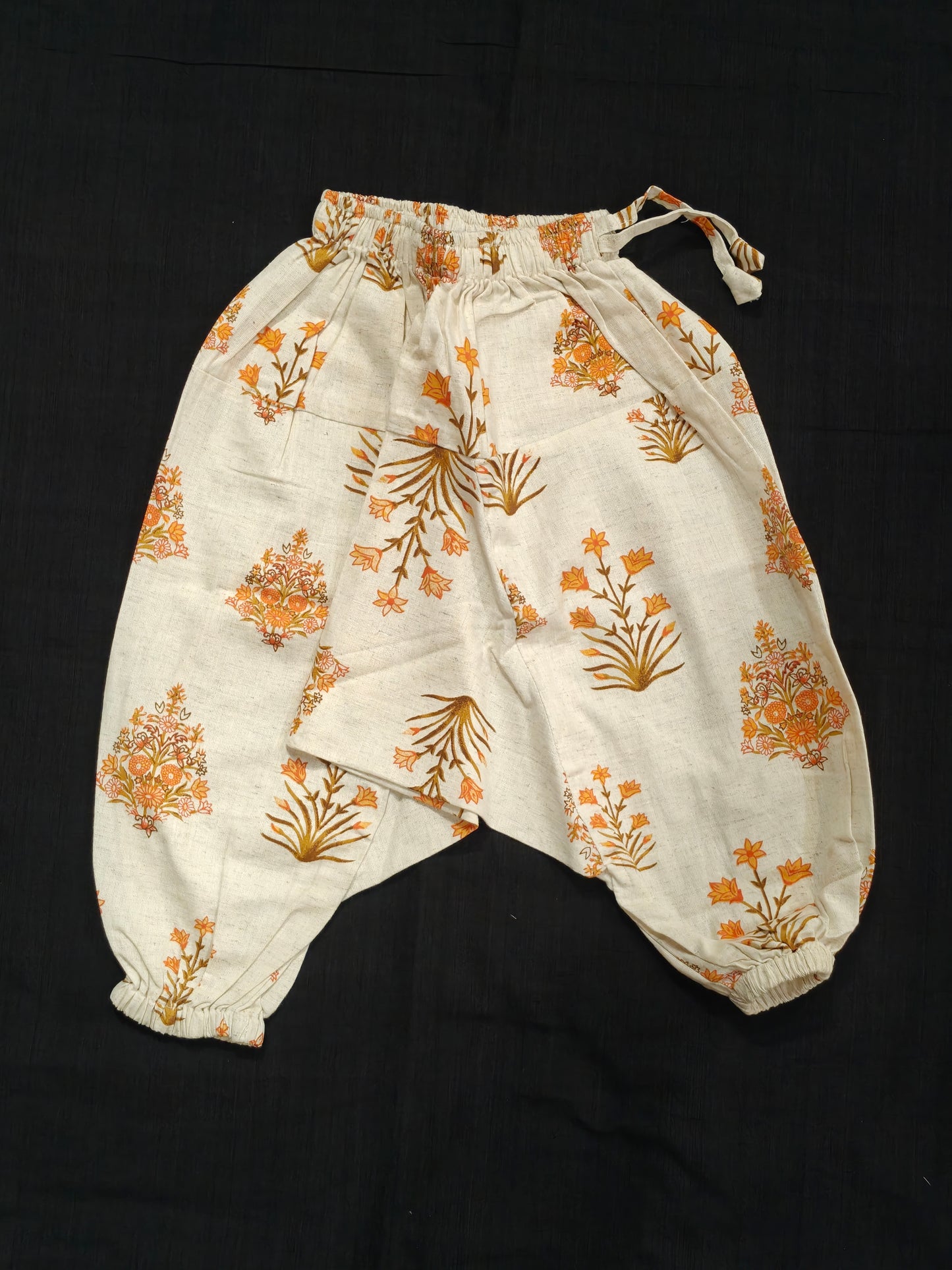 Orange floral handblock printed off white harem pants for children