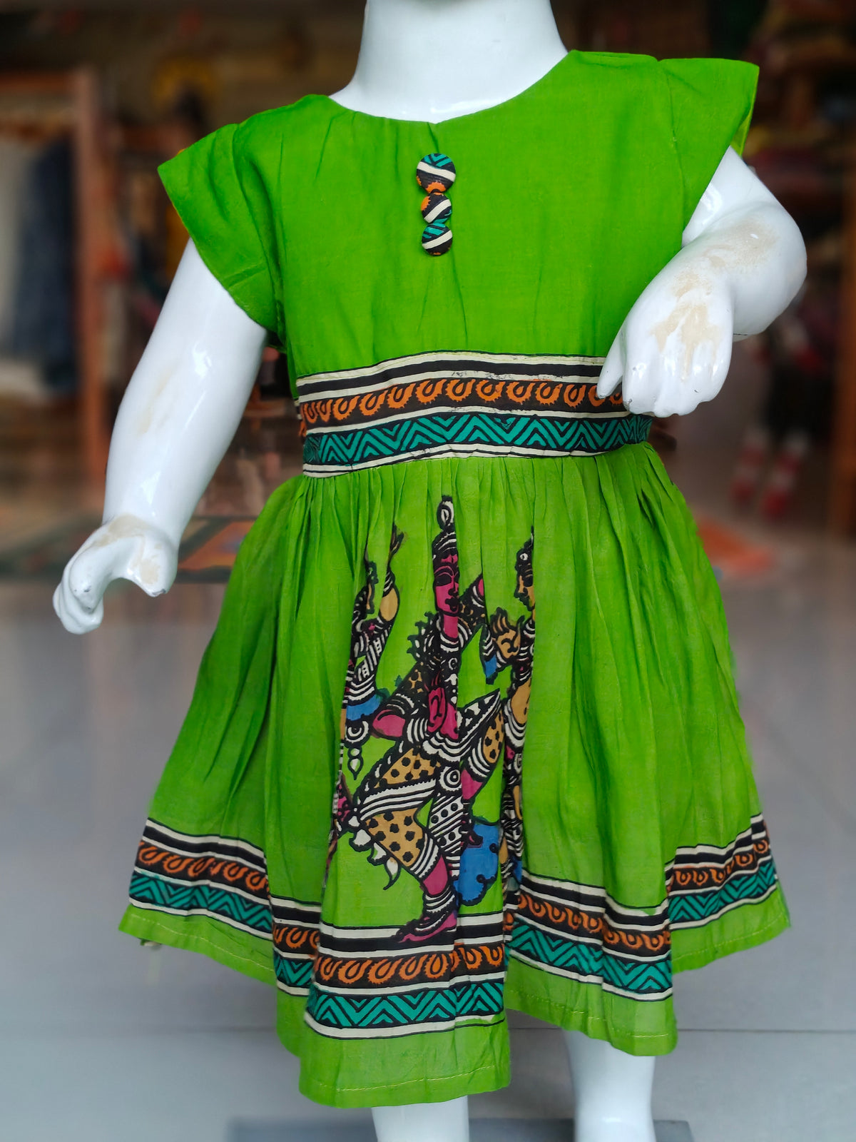 Vibrant parrot green pen kalamkari hand-painted silk frock with contrasting borders for little girls