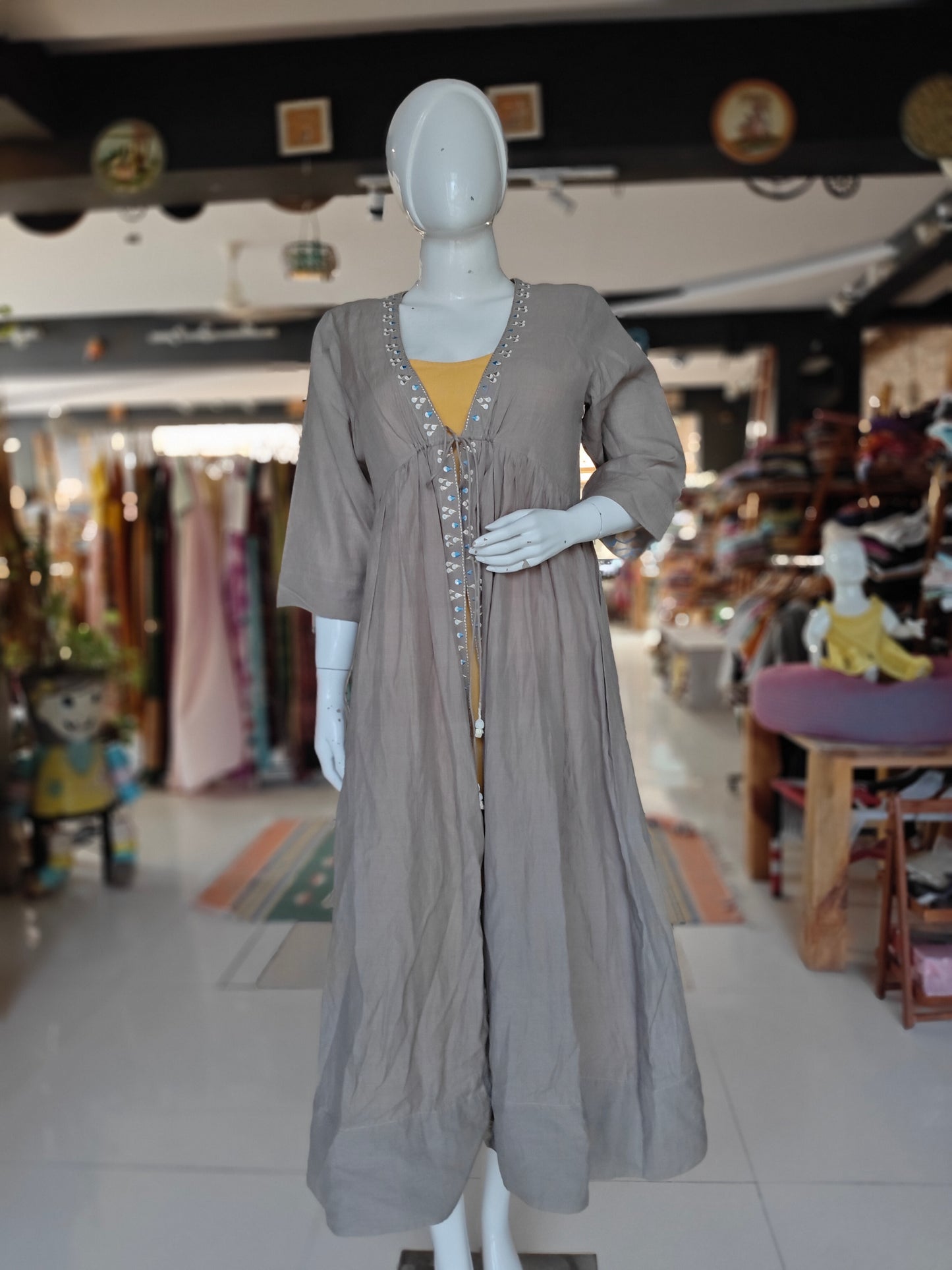 Plain yellow kurti with light grey brown embroidered jacket