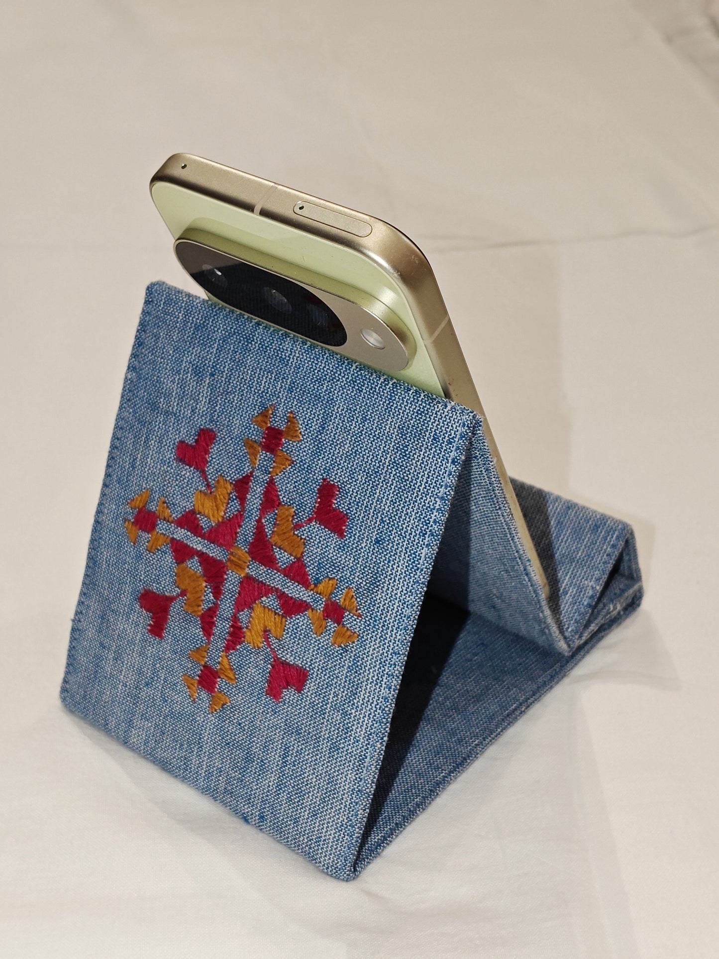 Light blue foldable fabric phone stand featuring decorative Phulkari hand embroidery