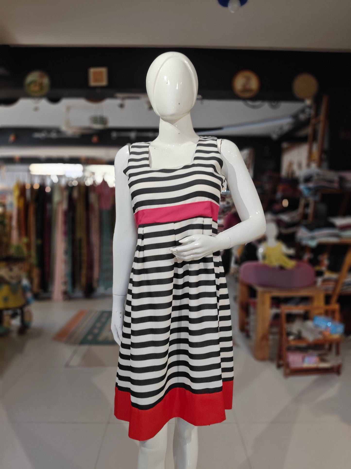 White and black striped skater dress with pink waist line and red hem