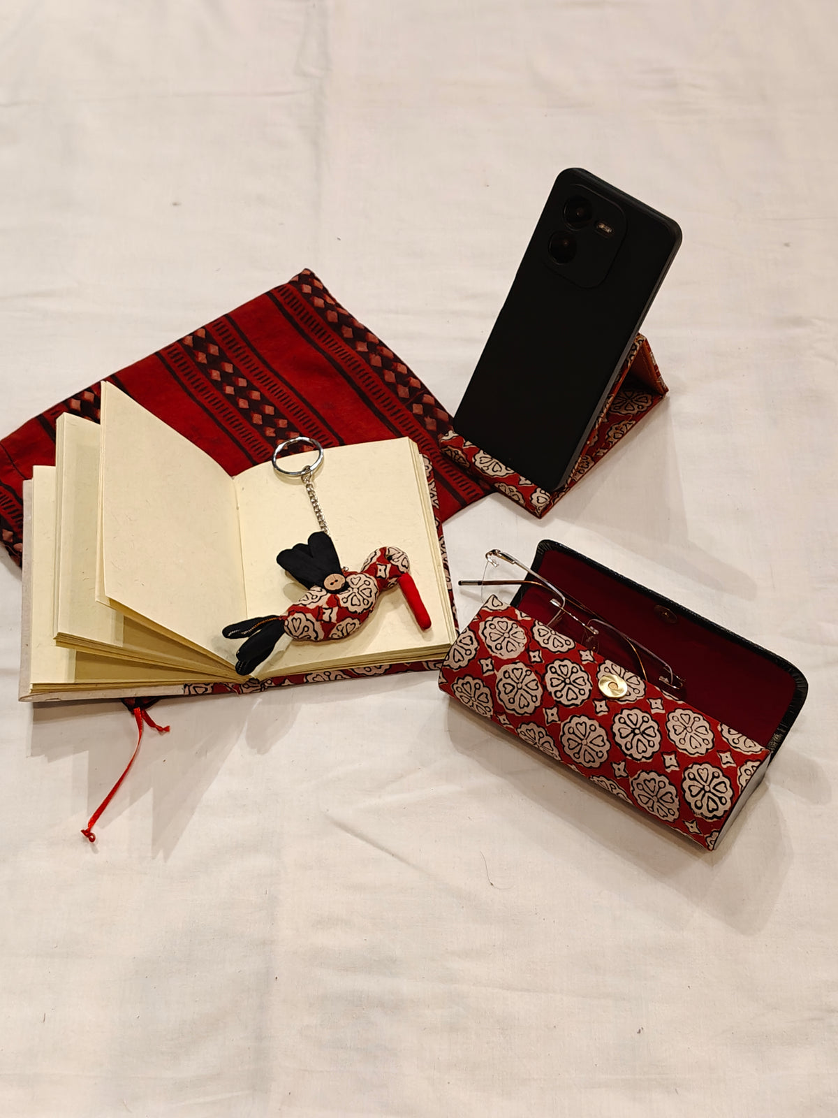 Handmade paper notebook with eco leaf printed fabric cover, bird design key ring / bag charm, mobile stand, spectacles box and a potli - gift set