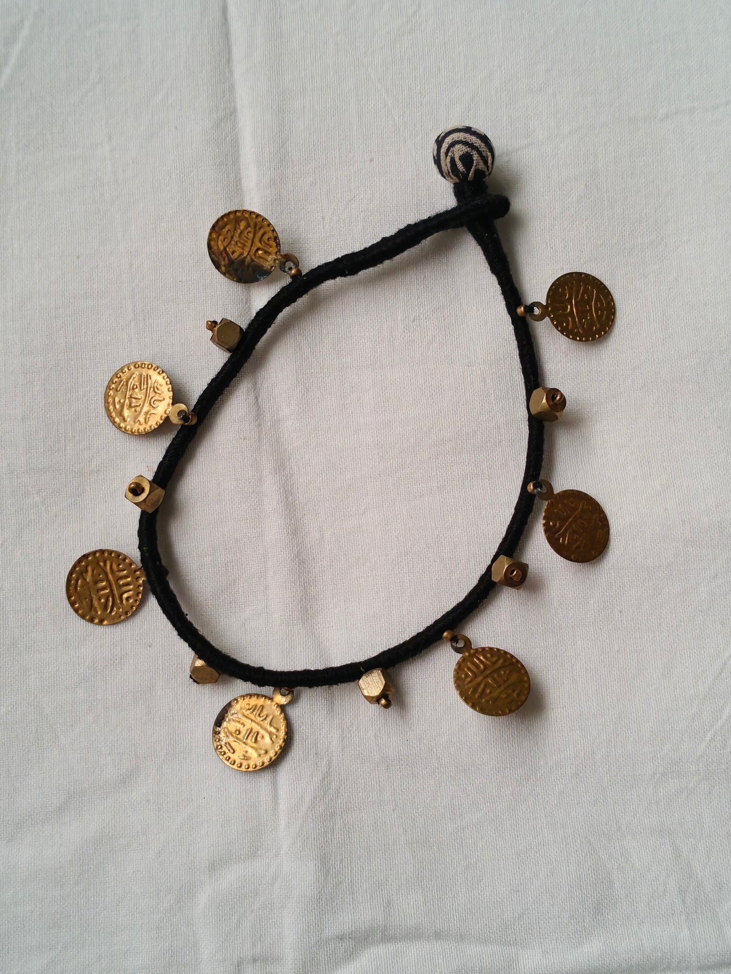 Brass single anklet with coins and beads in black thread