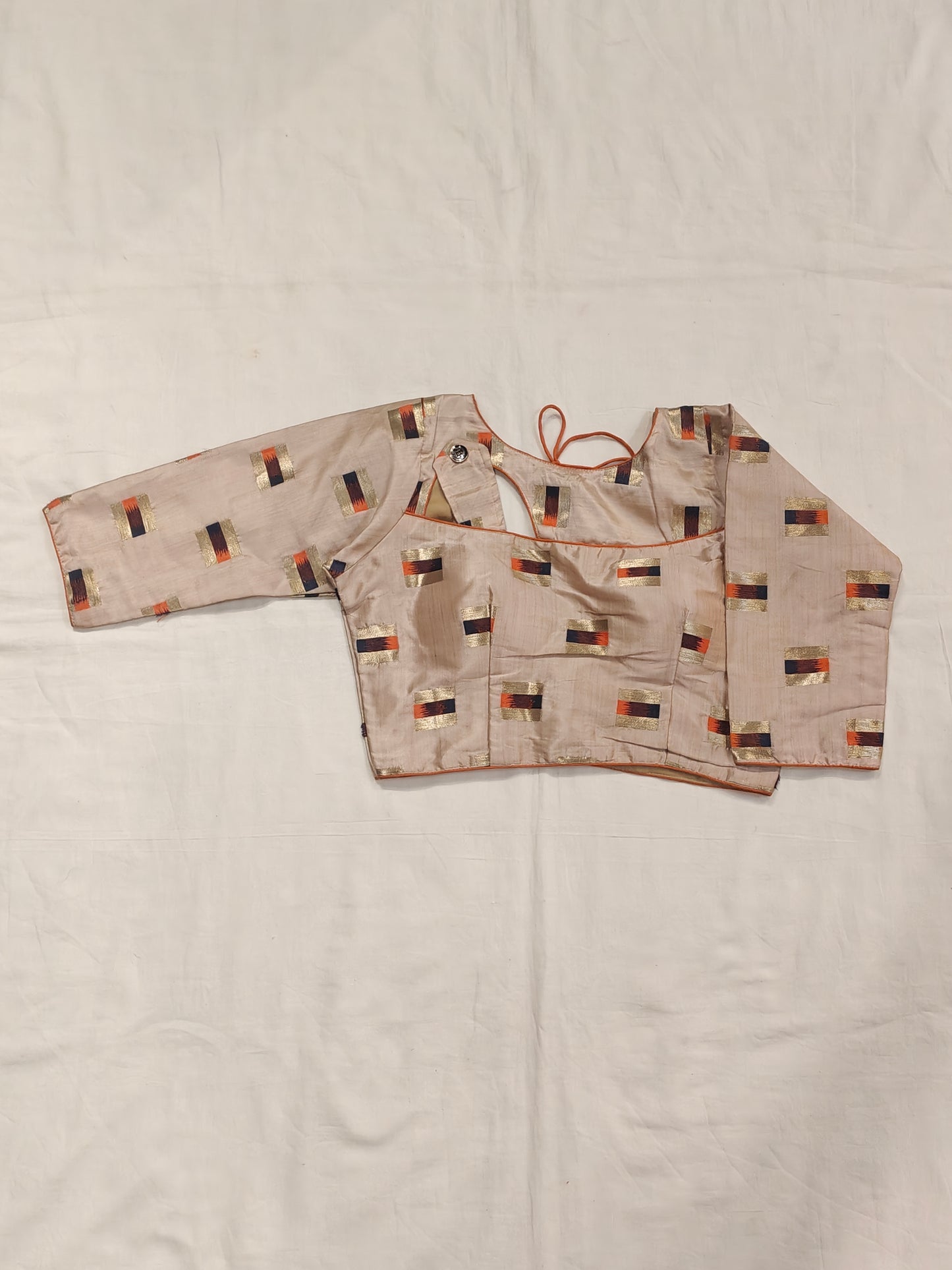 Gold orange design on cream base blouse with fancy neck cut