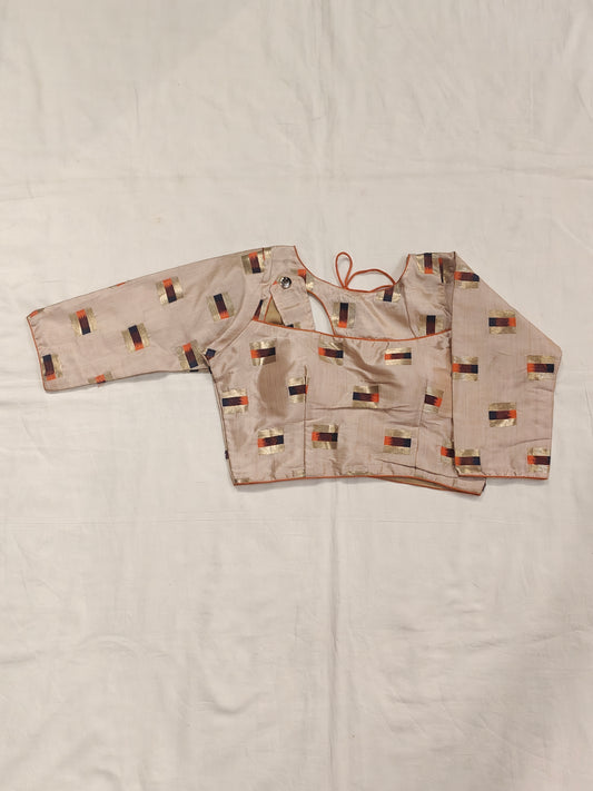 Gold orange design on cream base blouse with fancy neck cut