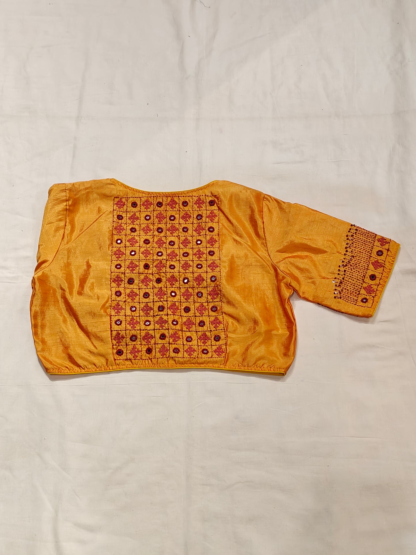 Orangeish yellow silk blouse with Kutchi hand mirror embroidery for back and sleeves
