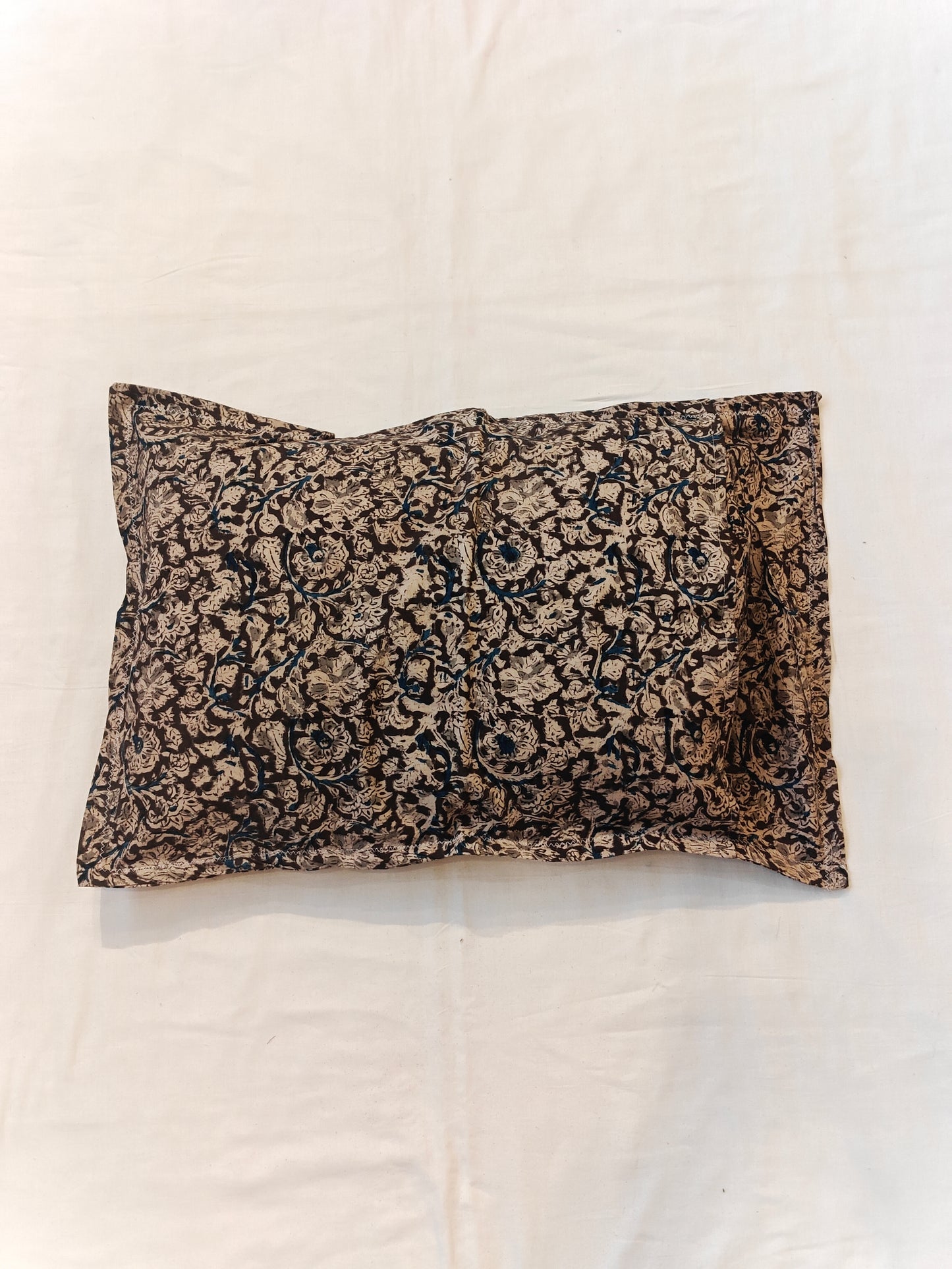 Handcrafted pillow cover featuring floral Kalamkari patterns