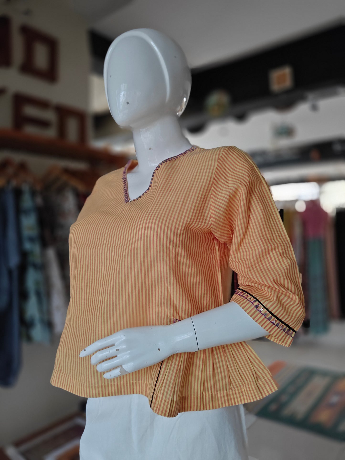 Orange and white striped cotton peplum top with embroidered V neck and sleeves
