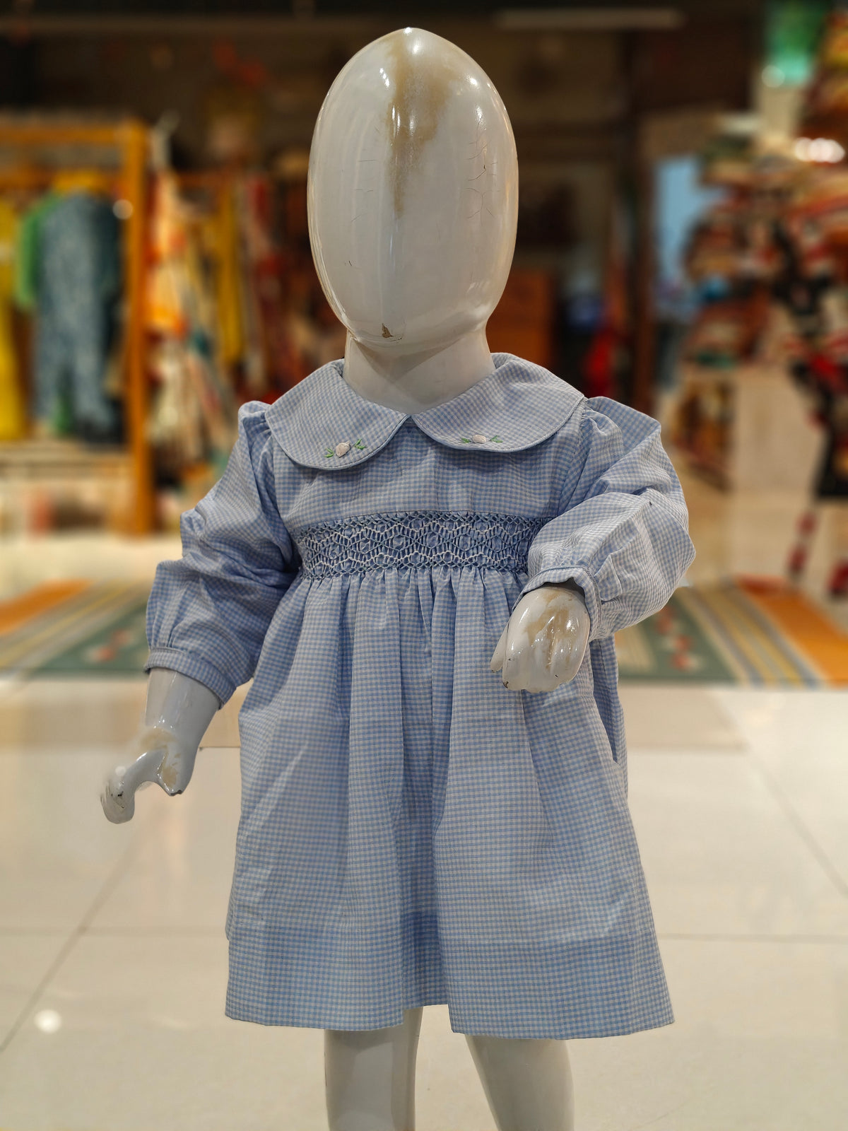 Checks smocking cotton frock for girls with embroidered Peter Pan collar and long sleeves