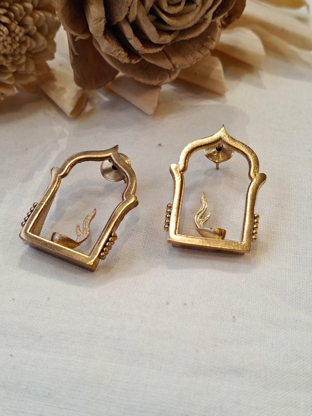 Jharokha frame enclosing burning diya design brass stud earrings