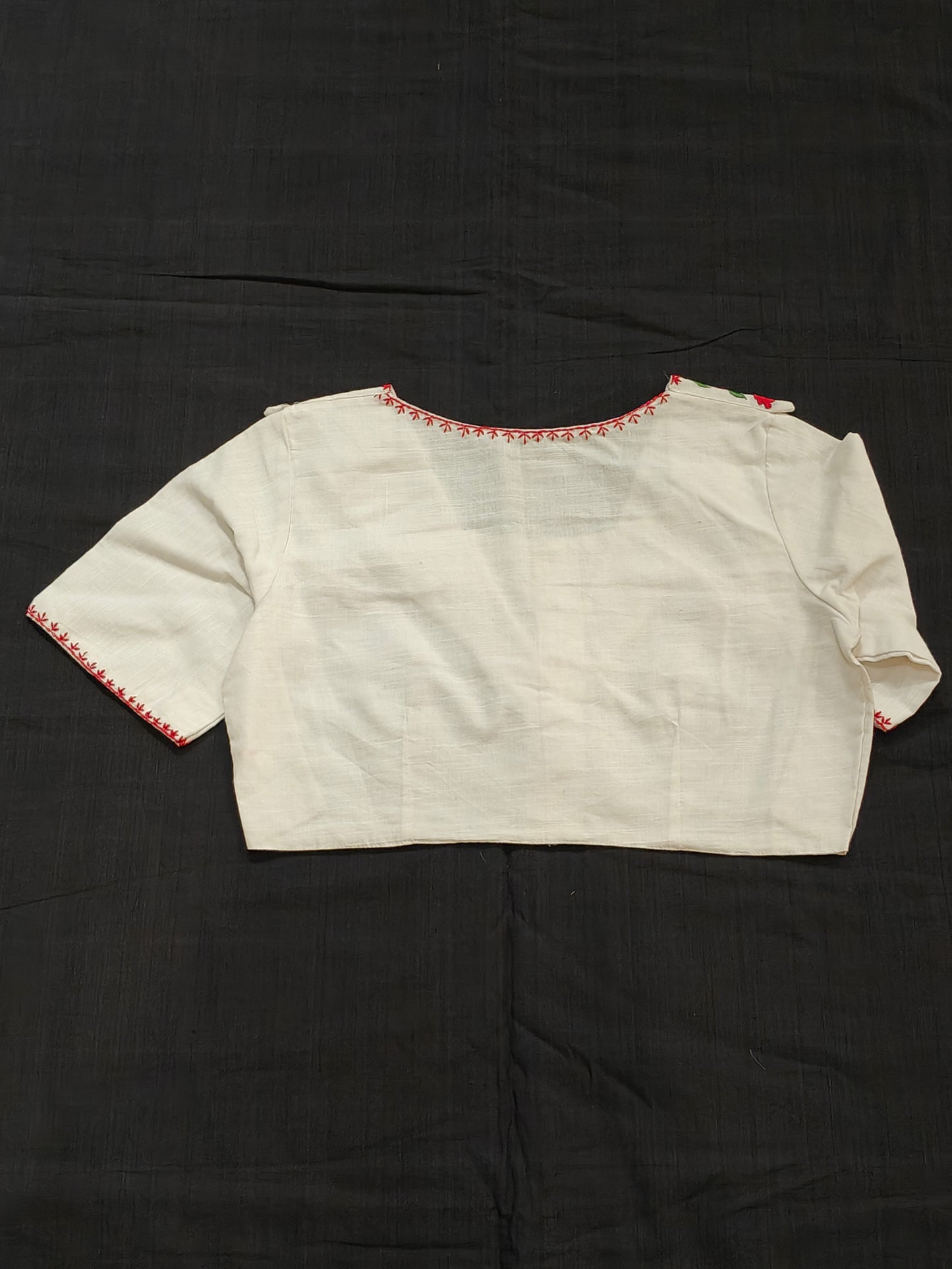 White blouse with red floral embroidery on dummy collar and sleeves - front open