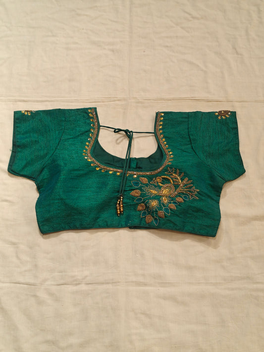 Green short sleeved blouse with beaded embroidery along the neckline and sleeves with peacock motif on back