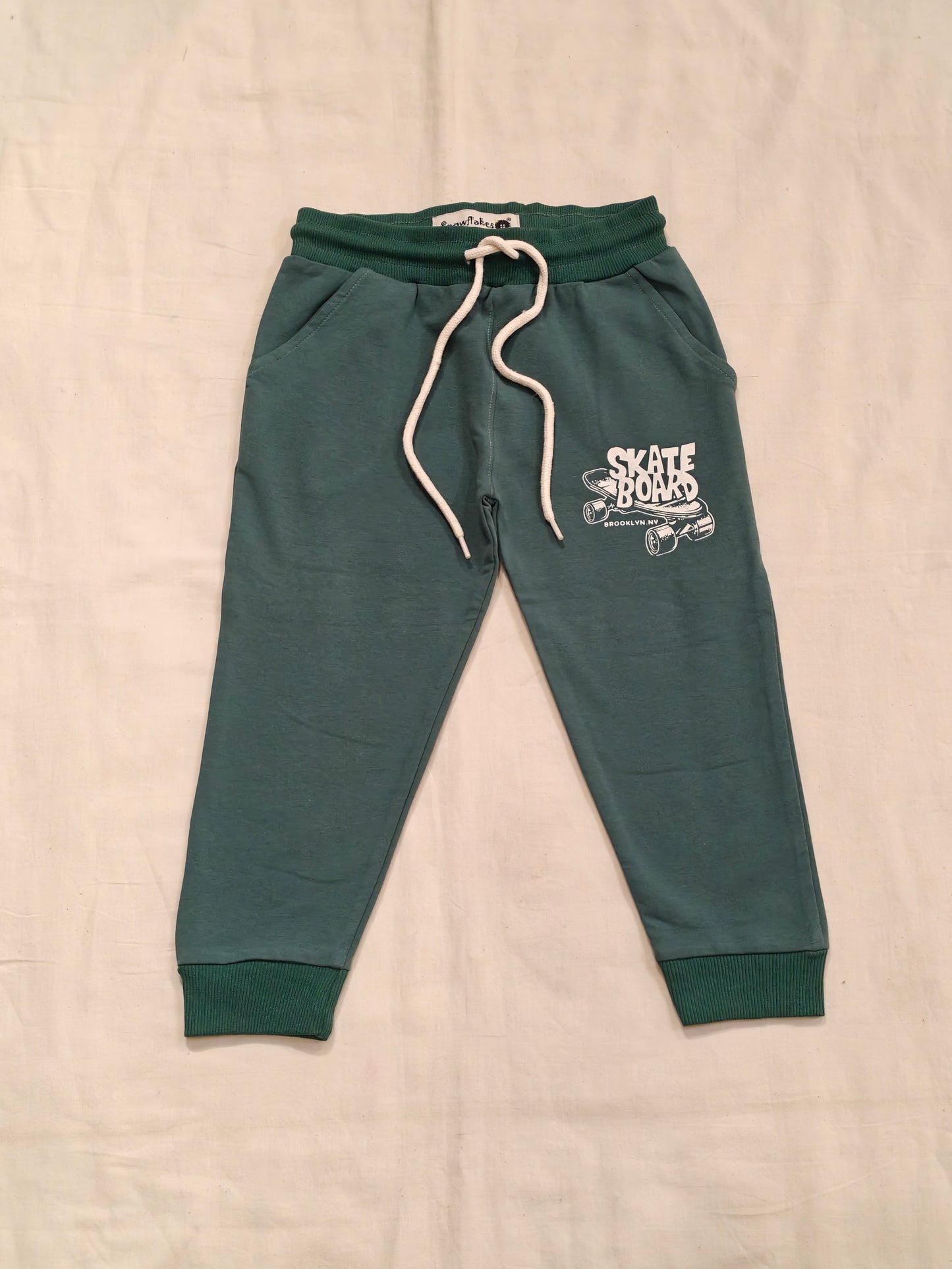 Green cotton jogger pants with skate board print for children