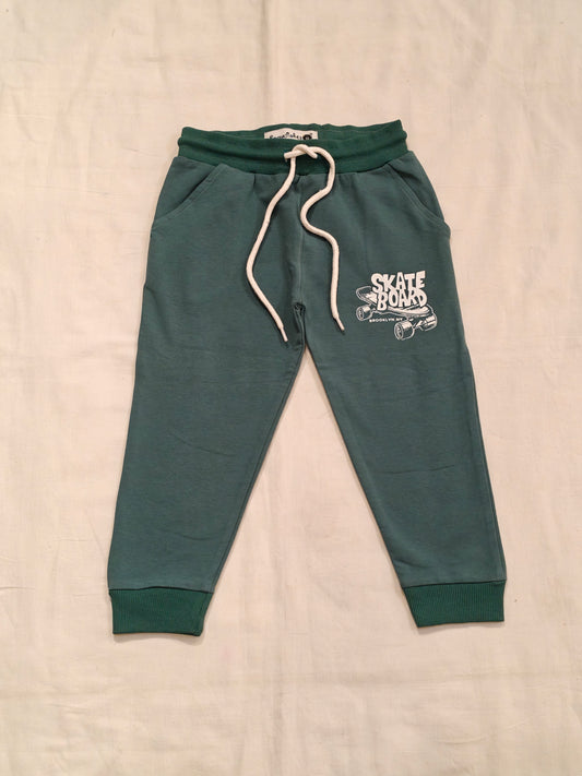 Green cotton jogger pants with skate board print for children