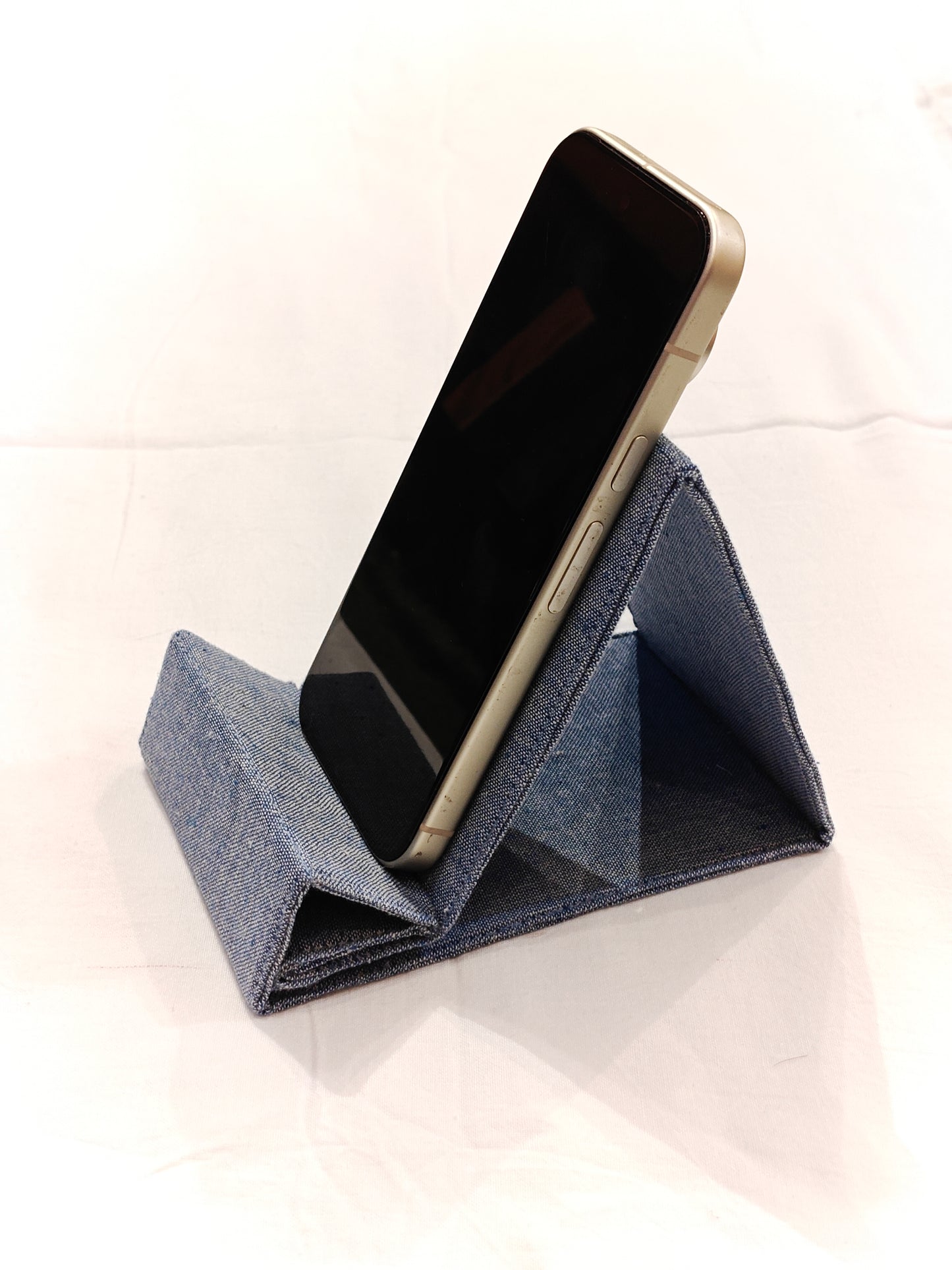 Light blue foldable fabric phone stand featuring decorative Phulkari hand embroidery