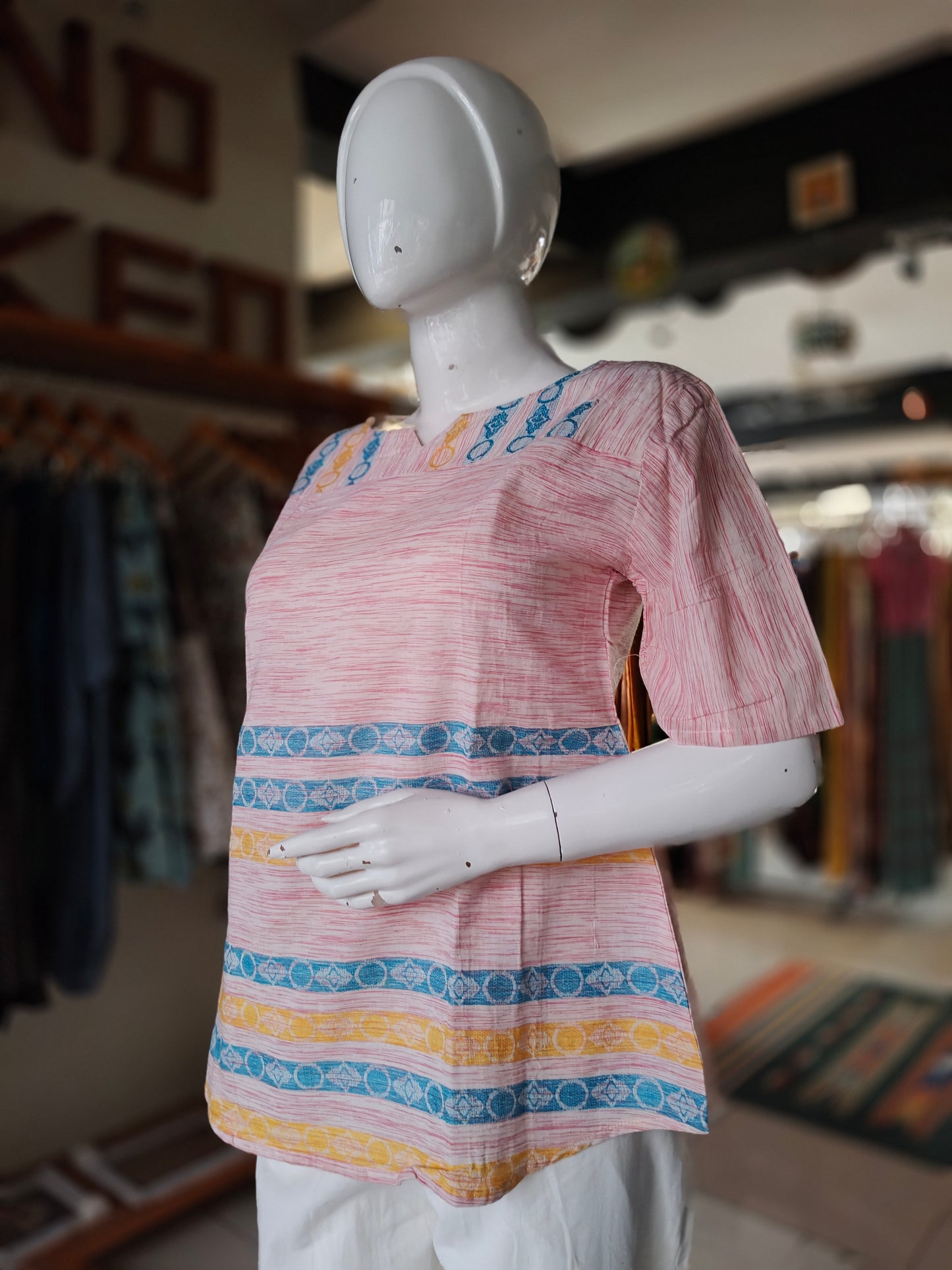 Pink handwoven cotton top with blue and yellow stripes