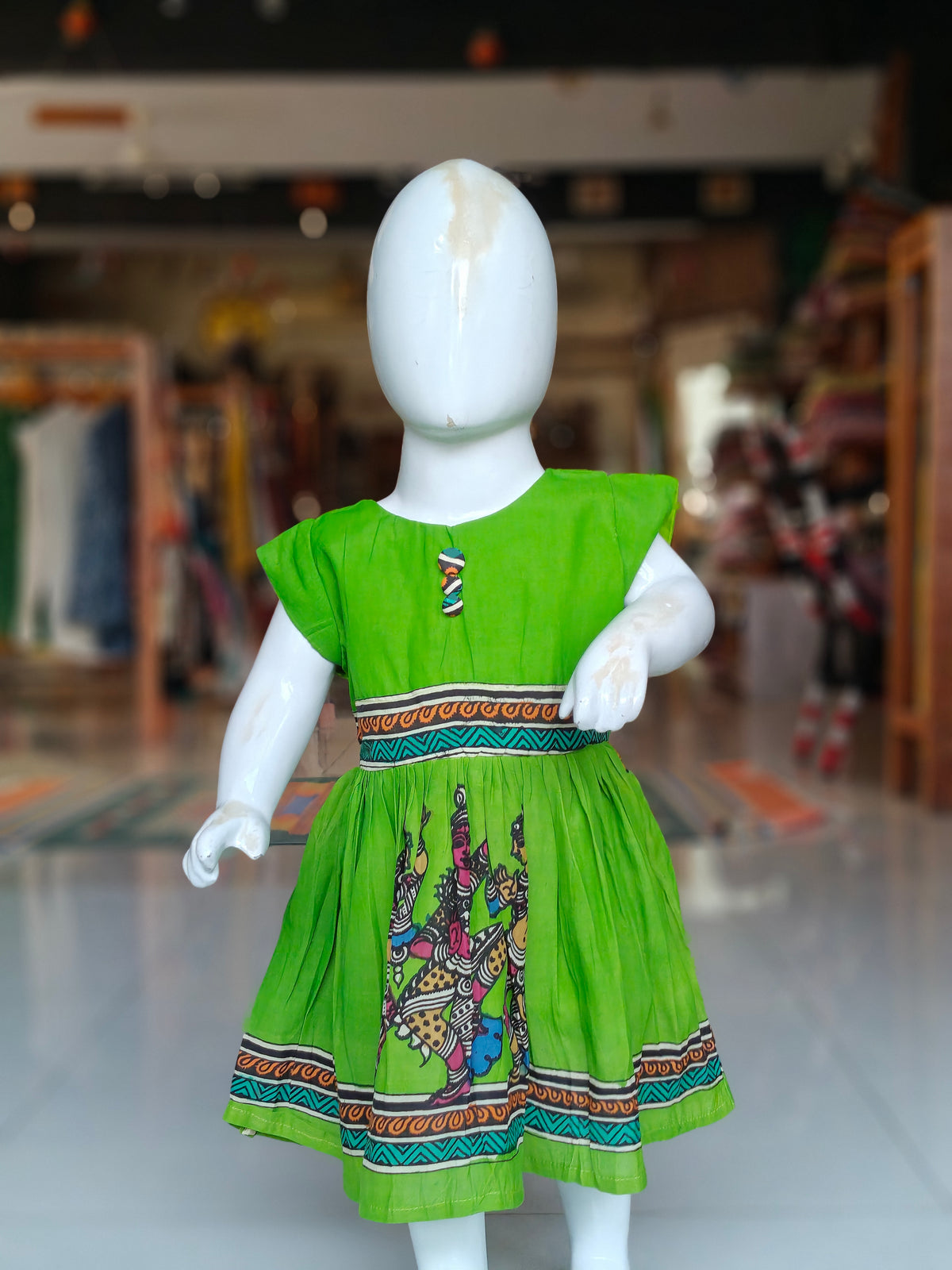 Vibrant parrot green pen kalamkari hand-painted silk frock with contrasting borders for little girls